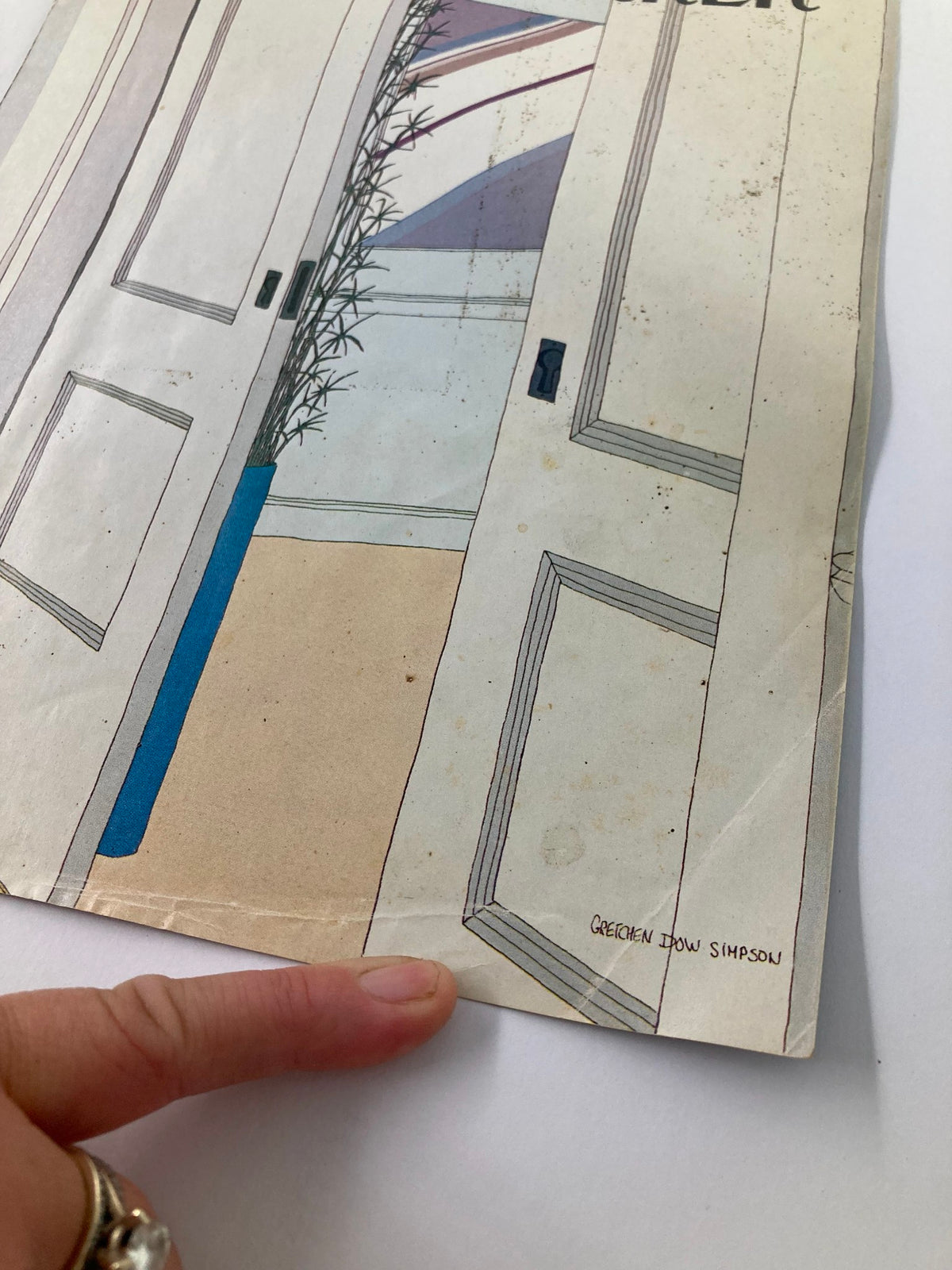 Detail shot of the corner of The New Yorker October 26 1981 Open Doors by Gretchen S. cover, highlighting the signature and wear, including a finger pointing at the corner.