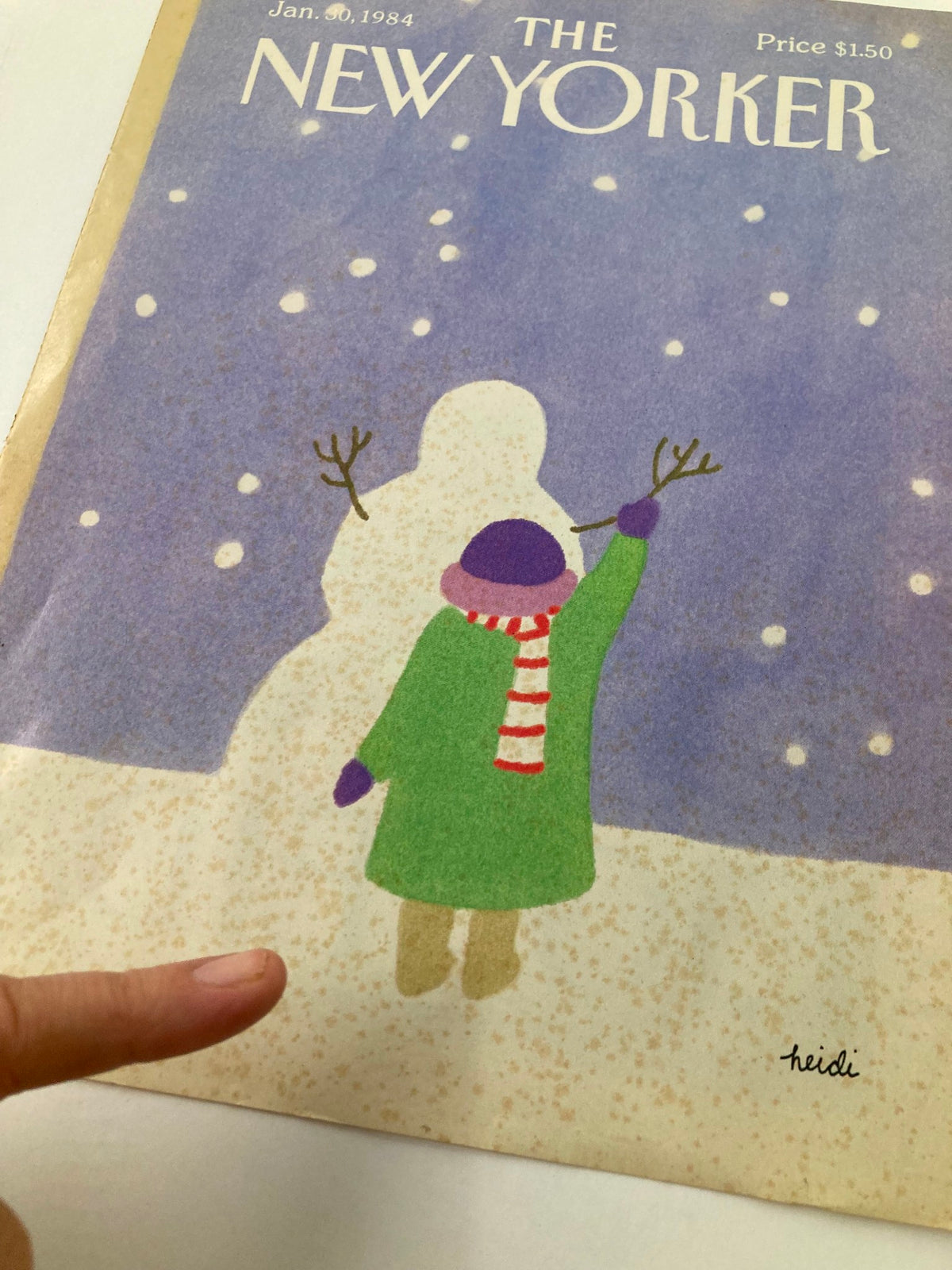 Cover of The New Yorker January 30, 1984 titled 'Building Snowman' by Heidi, featuring a whimsical illustration of a child in a green coat and purple hat creating a snowman in a snowy landscape.