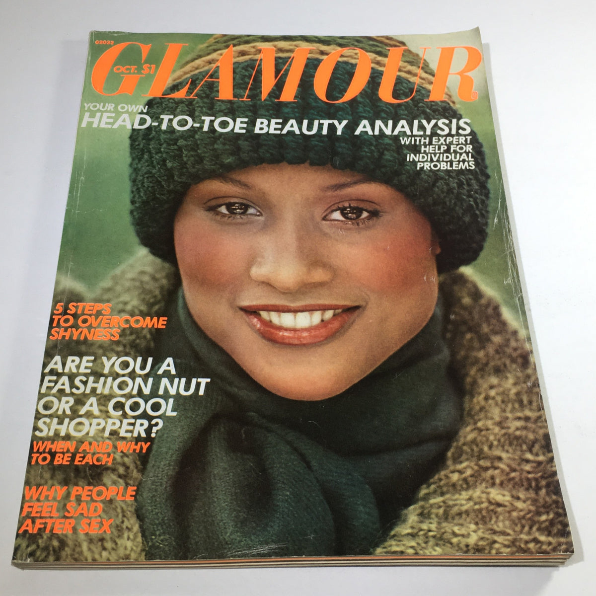Vintage Glamour Magazine from October 1975 featuring Beverly Johnson on the cover, showcasing a smiling model in a green knit hat and scarf, with headlines about beauty and fashion analysis.