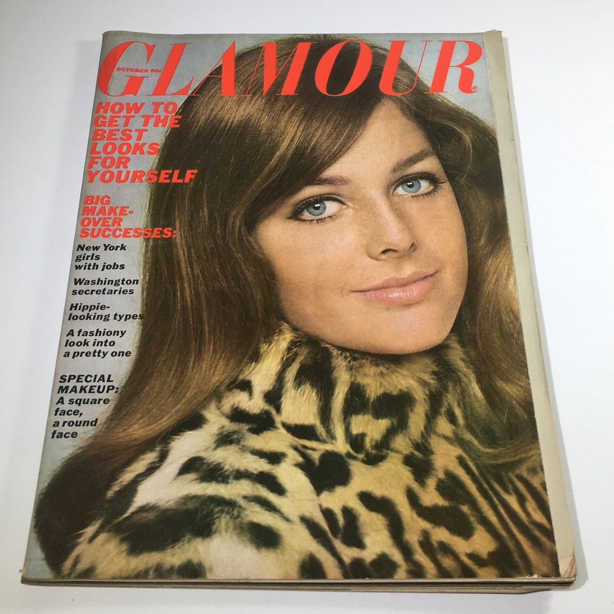 Cover of VTG Glamour Magazine from October 1967 featuring a model with long hair and blue eyes, dressed in a leopard print coat, highlighting the magazine's focus on fashion and beauty trends of the era.
