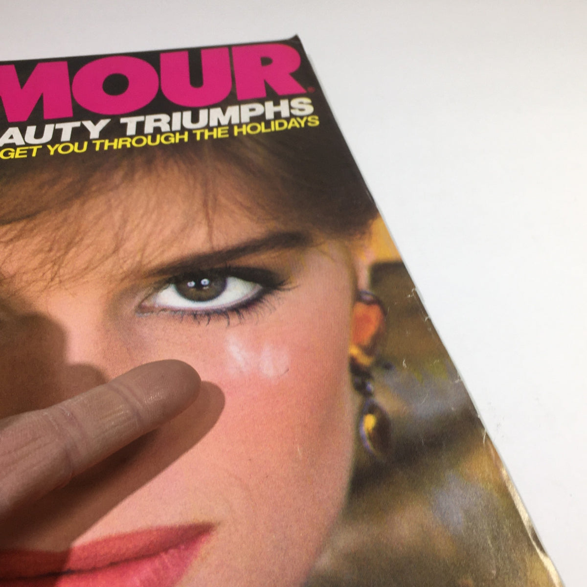 Vintage Glamour Magazine December 1982 with a detailed close-up of the model's face, highlighting beauty features and cover details, representing the essence of 1980s fashion.