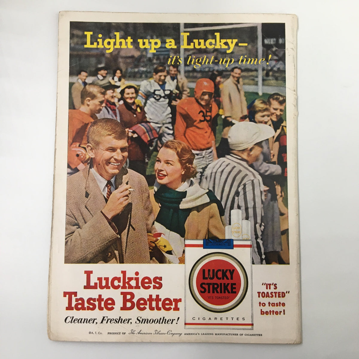Vintage advertisement featuring a man interviewing a woman at a sporting event, promoting Lucky Strike cigarettes, from the November 3, 1956 NCAA Football Stanford Cardinal vs. UCLA Bruins Goal Post Program.