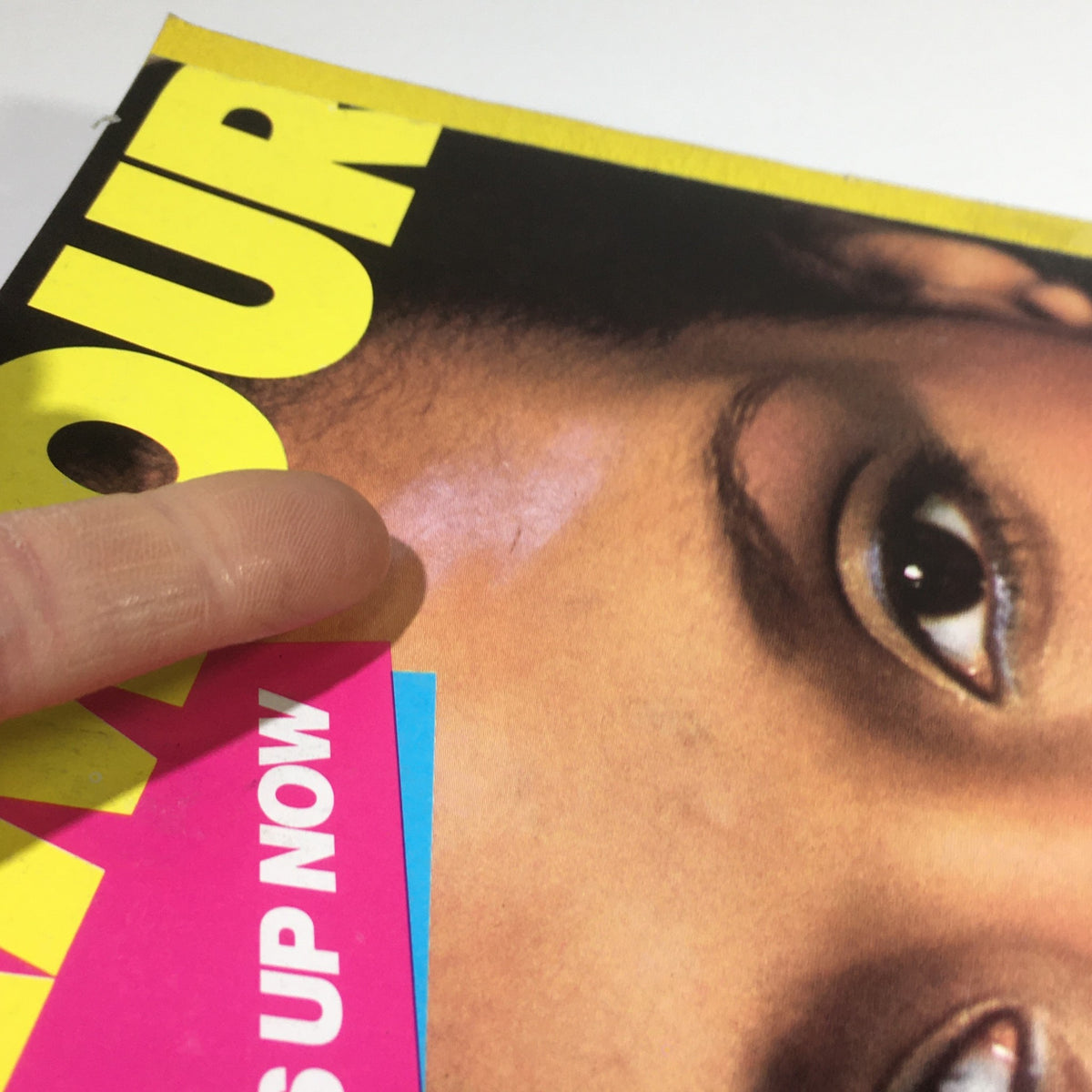 Close-up of the Vintage Glamour Magazine cover from November 1983 showing details of Beverly Johnson's face and text emphasizing fashion tips.