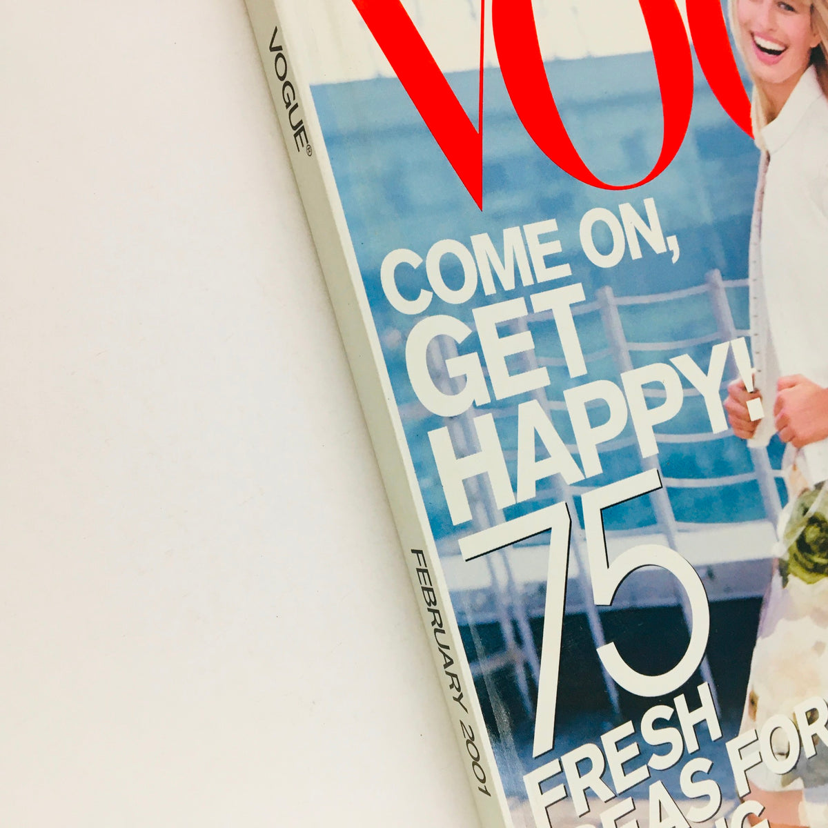 Close-up of the Vogue Magazine February 2001 cover highlighting the text and logo, featuring Czech Model Karolína Kurková, with a focus on the tagline 'Come on, get happy!' and details of the magazine's design.