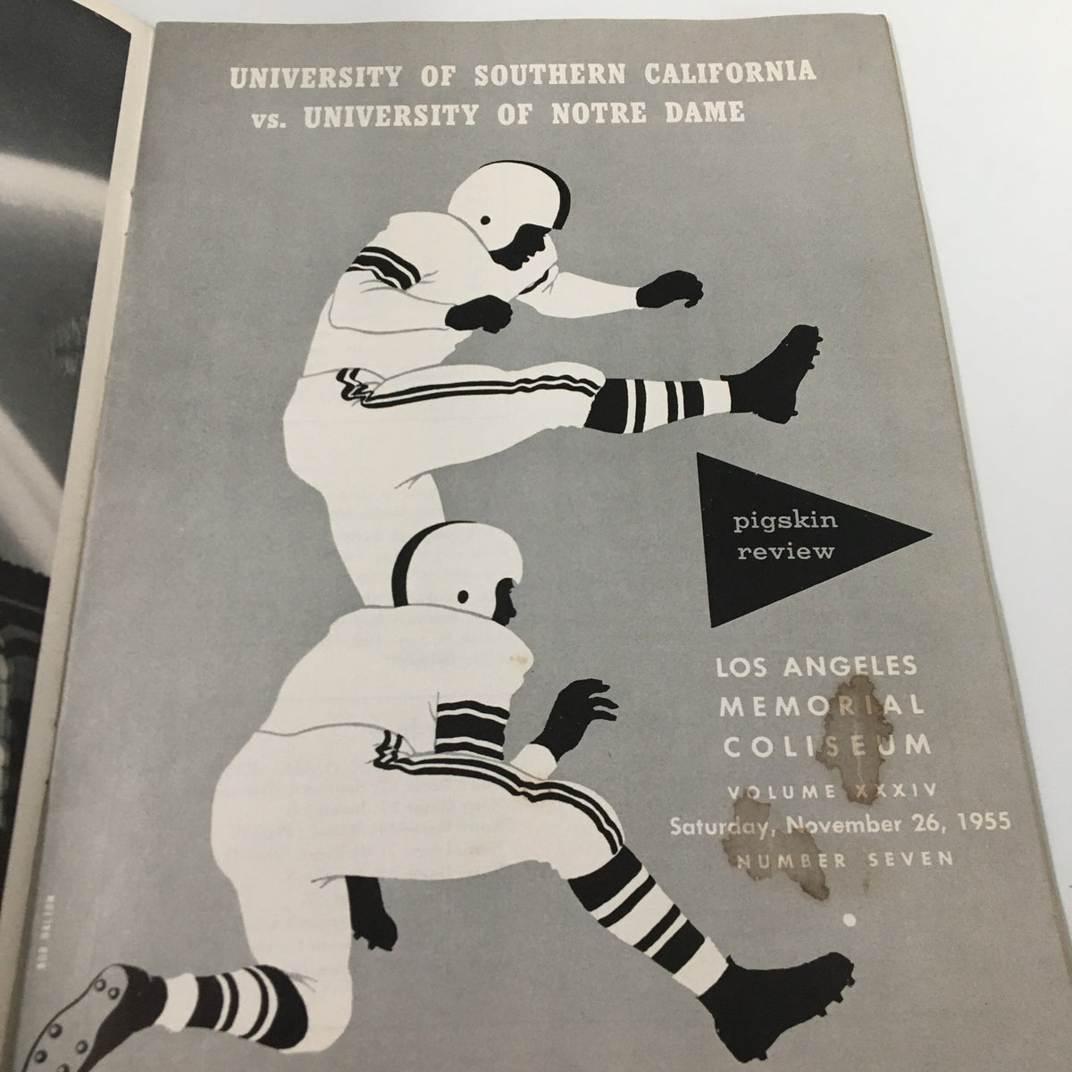 Interior page of the November 26, 1955 NCAA Football USC vs University of Notre Dame Pigskin Review, displaying artwork of football players in action, representing the excitement of the game.