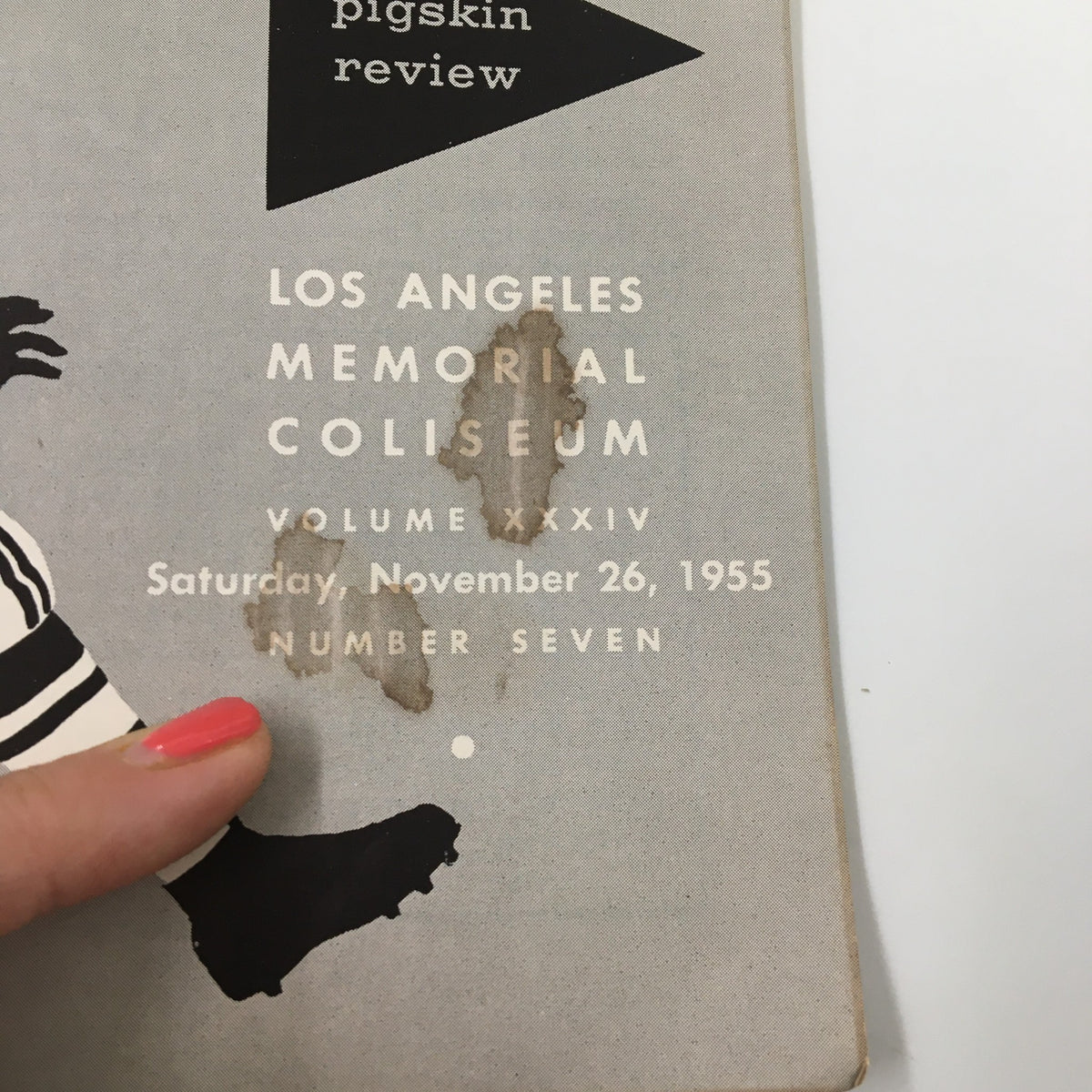 Close-up of the interior page from the November 26, 1955 NCAA Football USC vs University of Notre Dame Pigskin Review, highlighting the details of the game location, Los Angeles Memorial Coliseum.