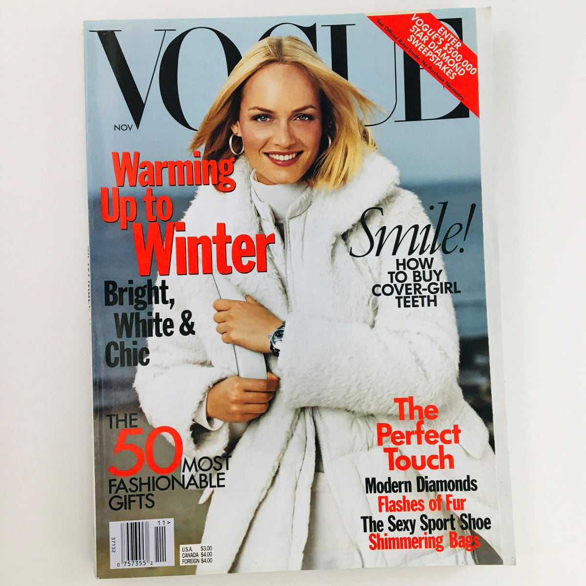 Vogue Magazine November 1998 cover featuring American model Amber Valletta with the headline 'Warming Up to Winter', highlighting fashionable gifts.