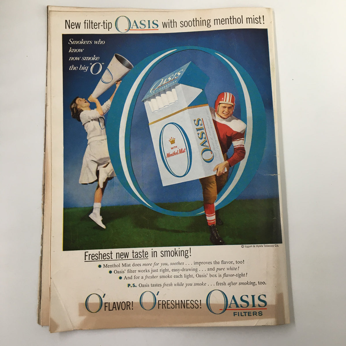 October 19, 1957 NCAA Football Program - Oregon State vs UCLA featuring an advertisement for Oasis cigarette filters, highlighting a player and a woman with a cigarette package.