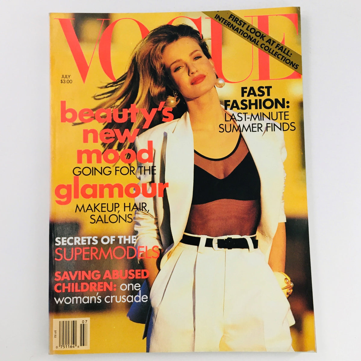 Vogue Magazine July 1991 featuring Dutch Model Karen Mulder on the cover, showcasing a fashion editorial theme with the headline 'beauty's new mood going for the glamour'. The magazine highlights beauty and fashion trends with vibrant colors and styling elements.