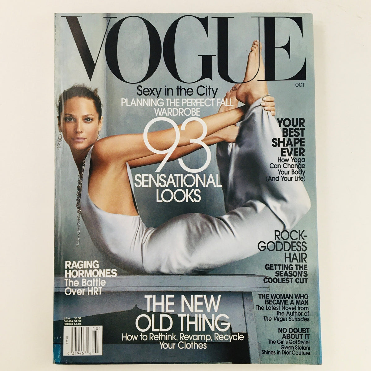 Cover of Vogue Magazine October 2002 featuring American supermodel Christy Turlington, showcasing a striking pose in a sleek outfit. Perfect for fashion collectors and enthusiasts.