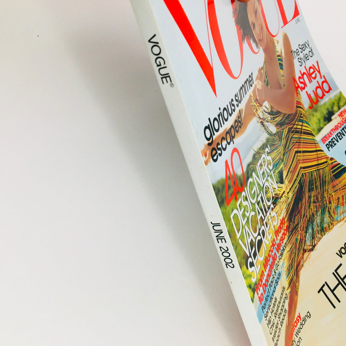 Side view of Vogue Magazine June 2002, showcasing the title and special features, including designers' vacation secrets.