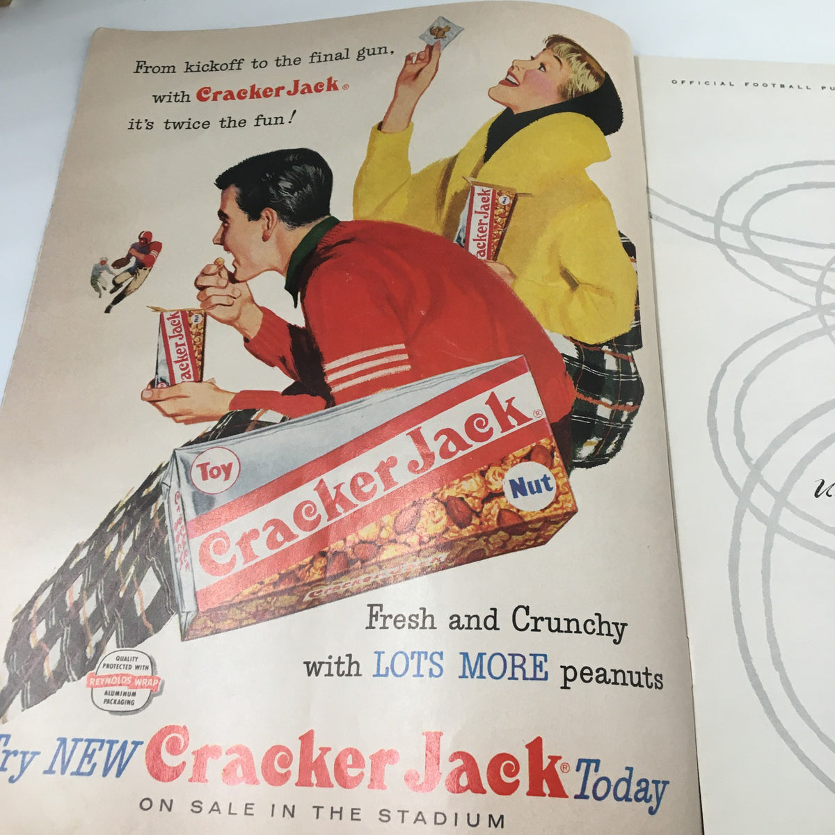 Vintage advertisement for Cracker Jack featured in the October 12 1957 NCAA Football UCLA Bruins Official Program, showcasing a fun and nostalgic snack experience at the stadium.