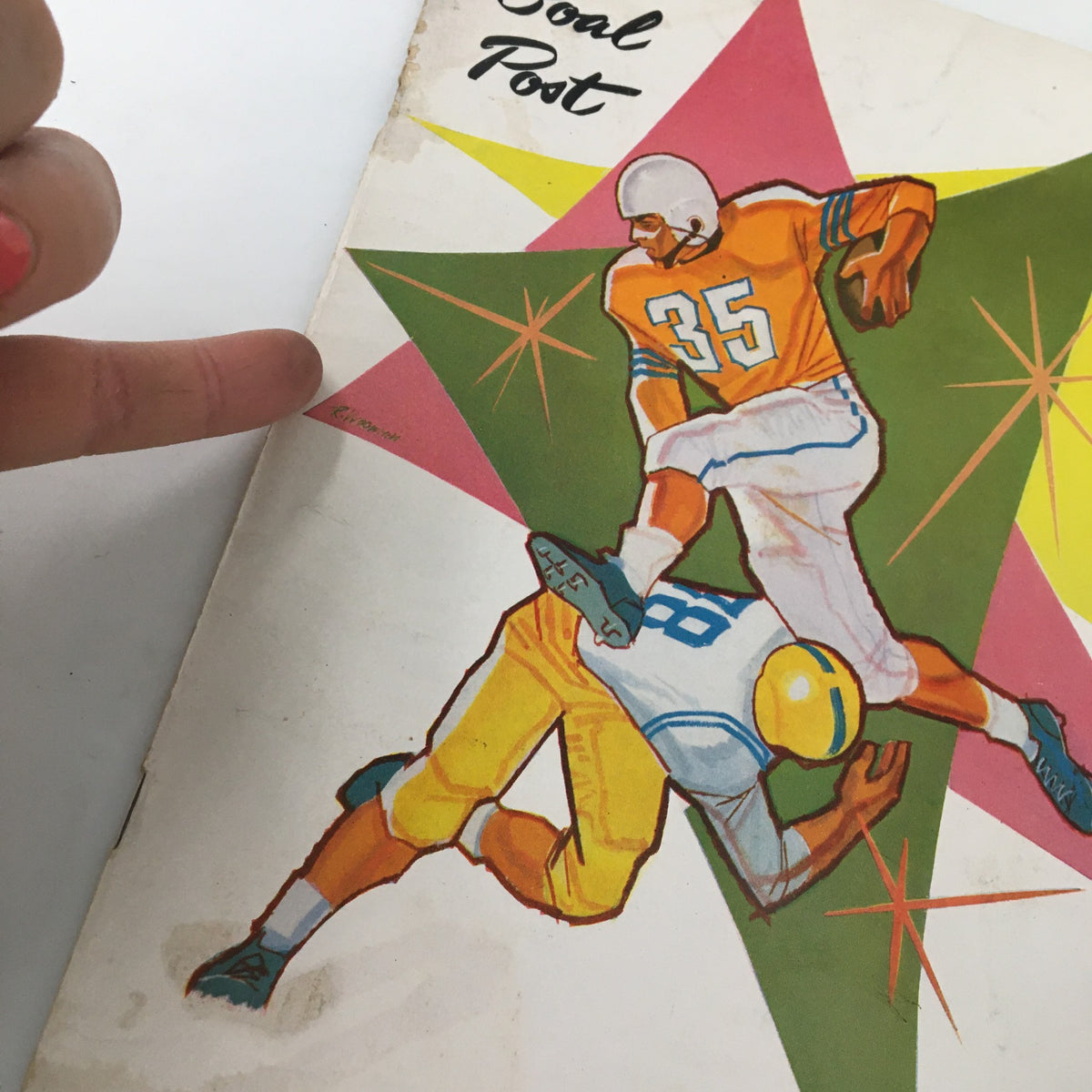 Cover art of the October 23 1959 NCAA Football UCLA Bruins vs Air Force Falcons booklet featuring an action illustration of a football player tackling another.
