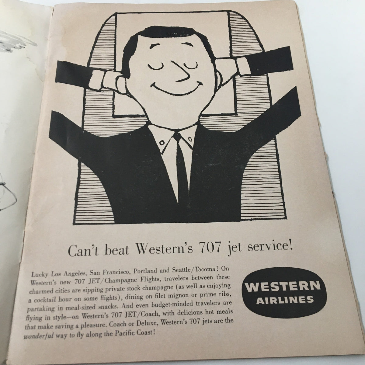 Advertisement page from the 'The Goal Post' booklet promoting Western Airlines, showcasing humorous illustration and travel service, related to the USC Trojans vs UCLA Bruins game on November 19, 1960.
