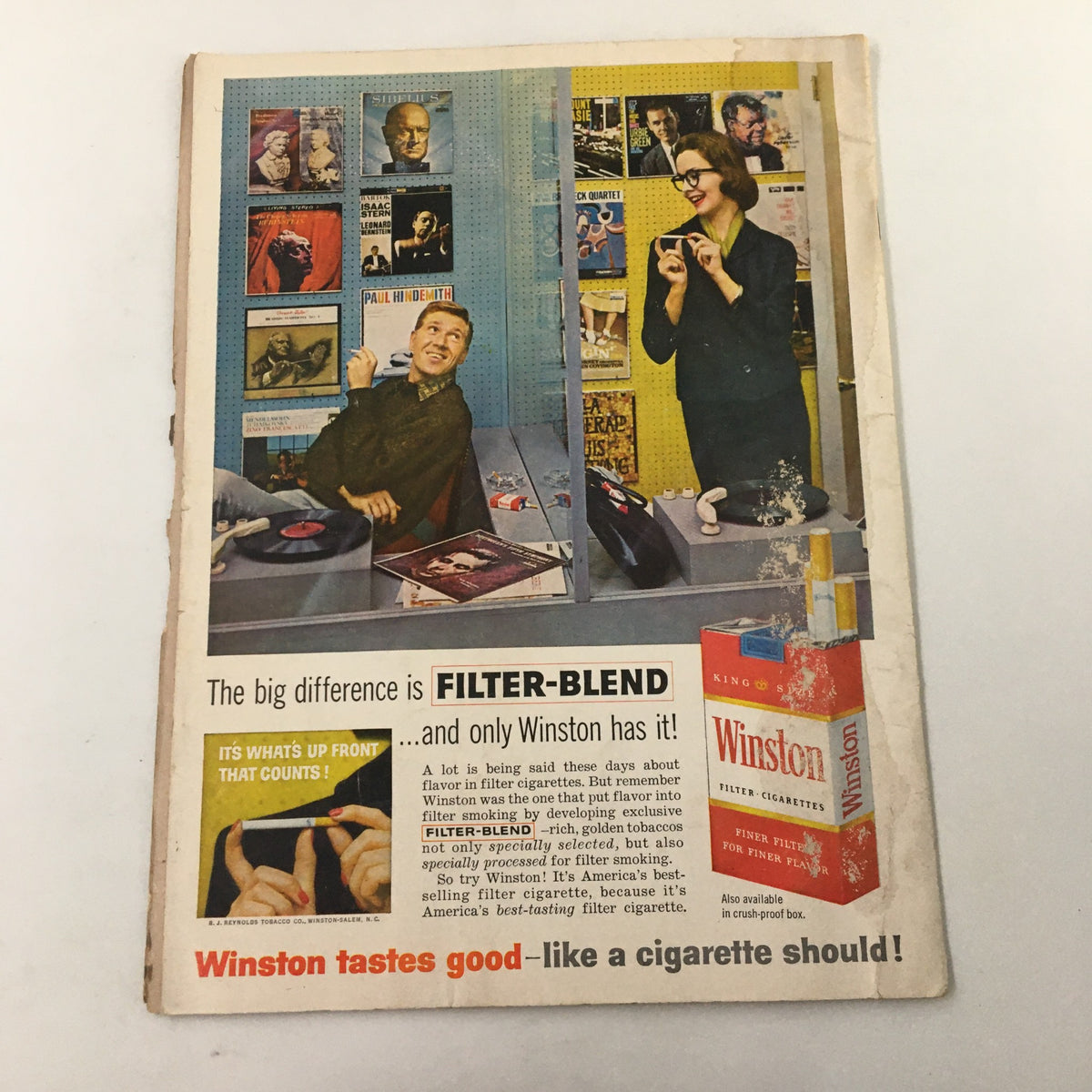 Vintage advertisement featuring two individuals promoting Winston cigarettes, alongside the caption 'The big difference is FILTER-BLEND... and only Winston has it!' This image relates to the nostalgic theme of the sports booklet 'The Goal Post,' detailing the November 19, 1960 NCAA football game between USC Trojans and UCLA Bruins.
