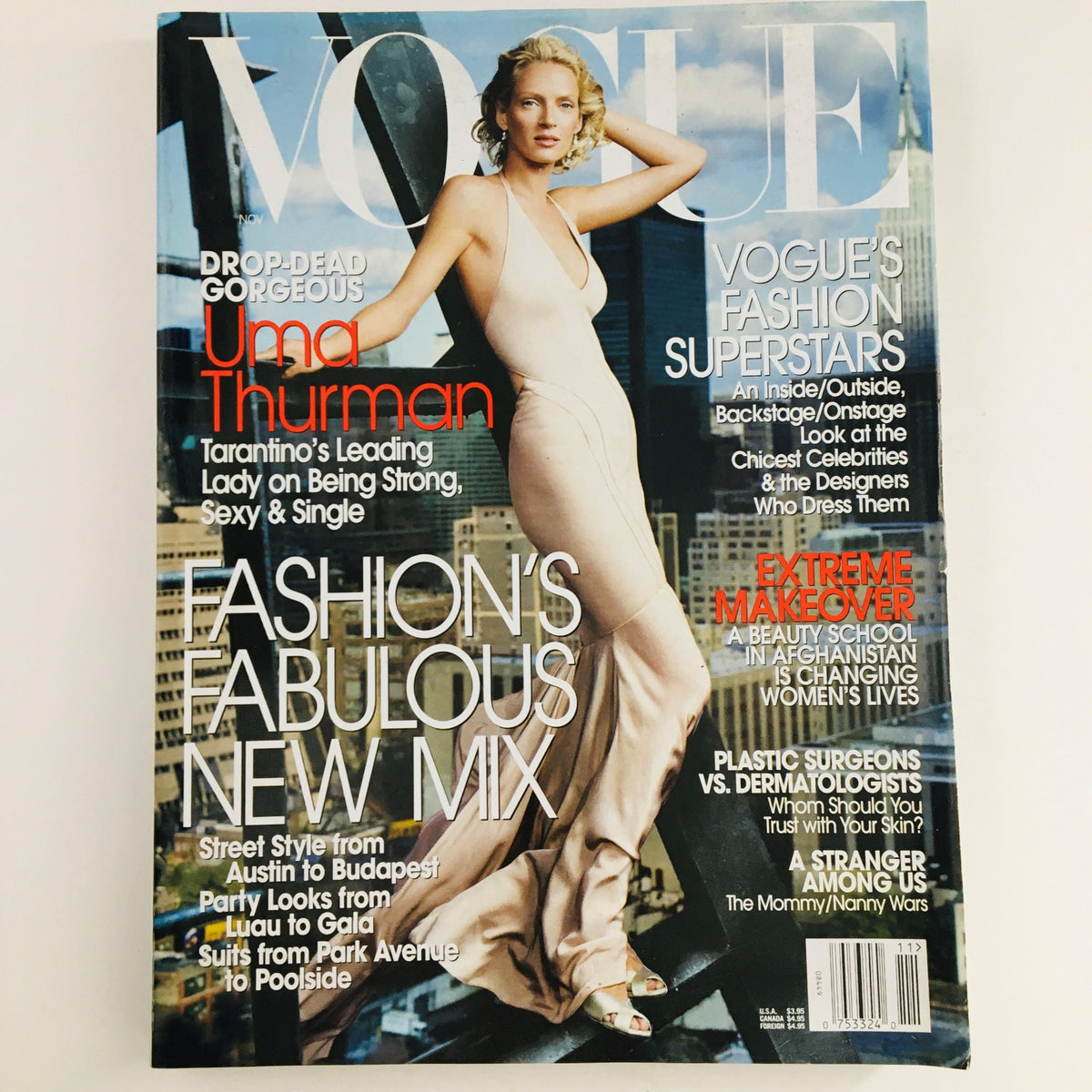 Vogue Magazine November 2003 featuring American actress Uma Thurman on the cover, showcasing her in a stunning dress, highlighting fashion trends of the early 2000s.