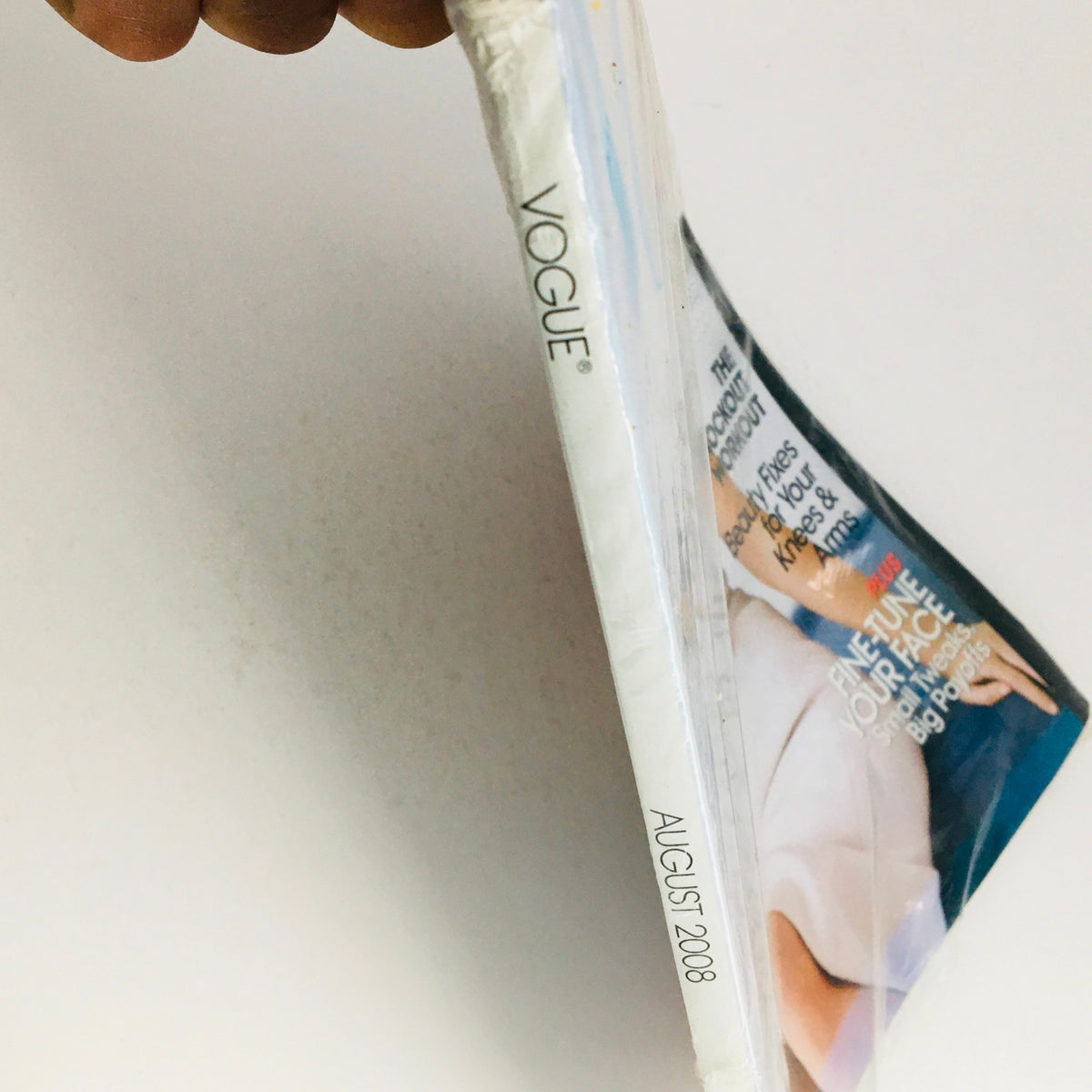 Side view of Vogue Magazine August 2008 showcasing the month and year prominently with the title 'Vogue' visible along with the magazine cover details featuring Kate Moss.