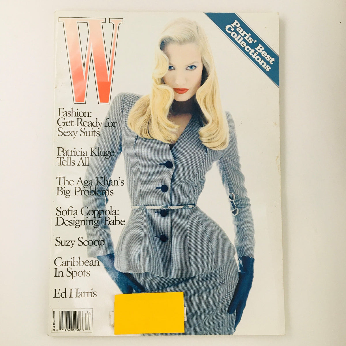 Cover of W Magazine from December 1994 featuring Dutch model Karen Mulder. Highlights include fashion tips for sexy suits and a feature on Ed Harris. Vintage magazine in good condition with minimal wear, protected by plastic covering.