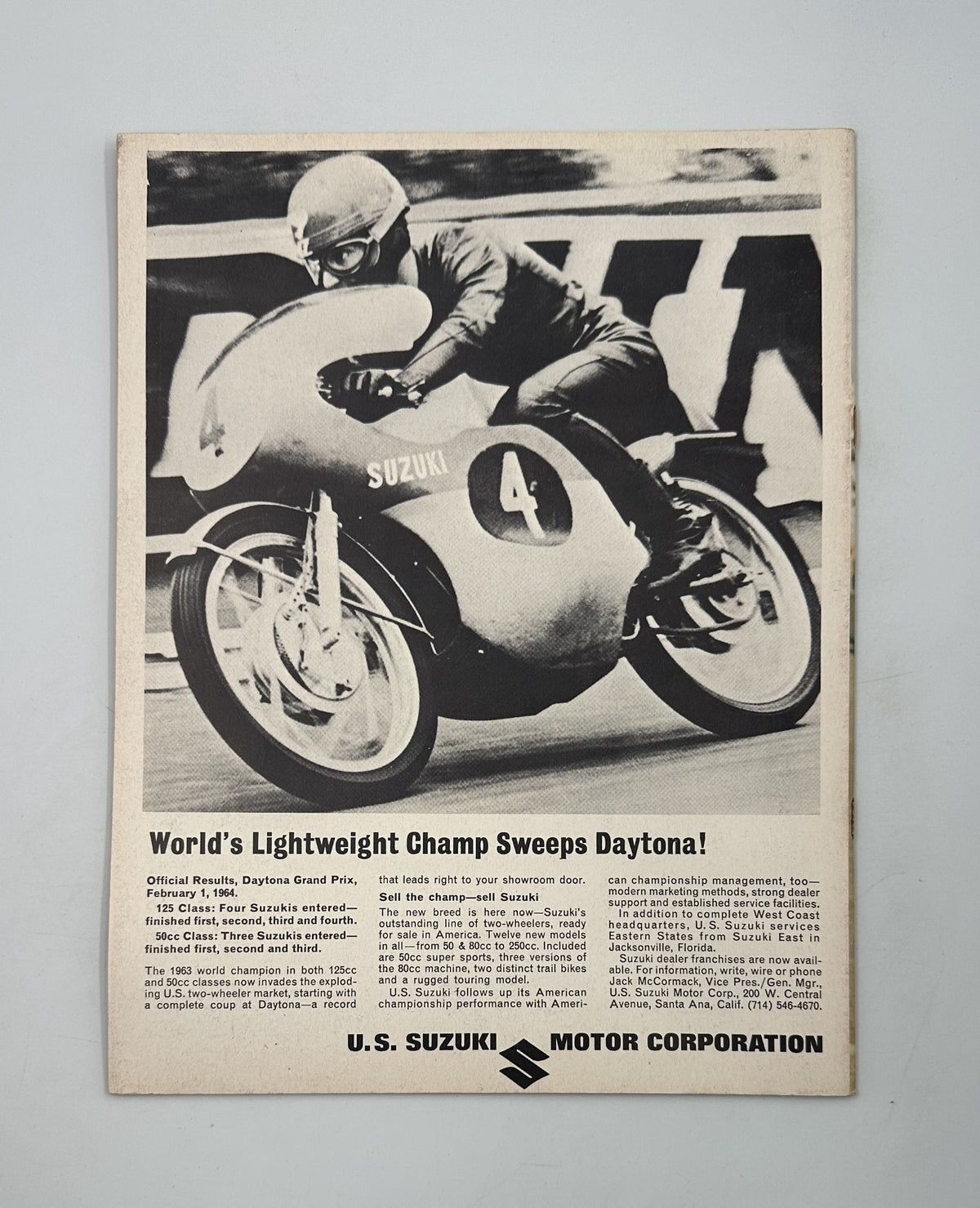 Advertisement page in Cycle Magazine May 1964 for U.S. Suzuki Motor Corporation featuring a motorcycle champion from the Daytona Grand Prix.