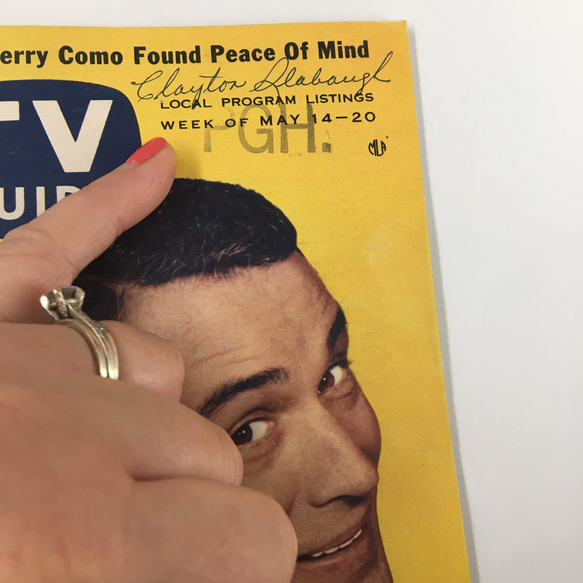 Close-up of TV Guide Magazine May 14 1955 featuring Perry Como, with hand positioned on the cover, emphasizing signature and local program listings for Pittsburgh edition.