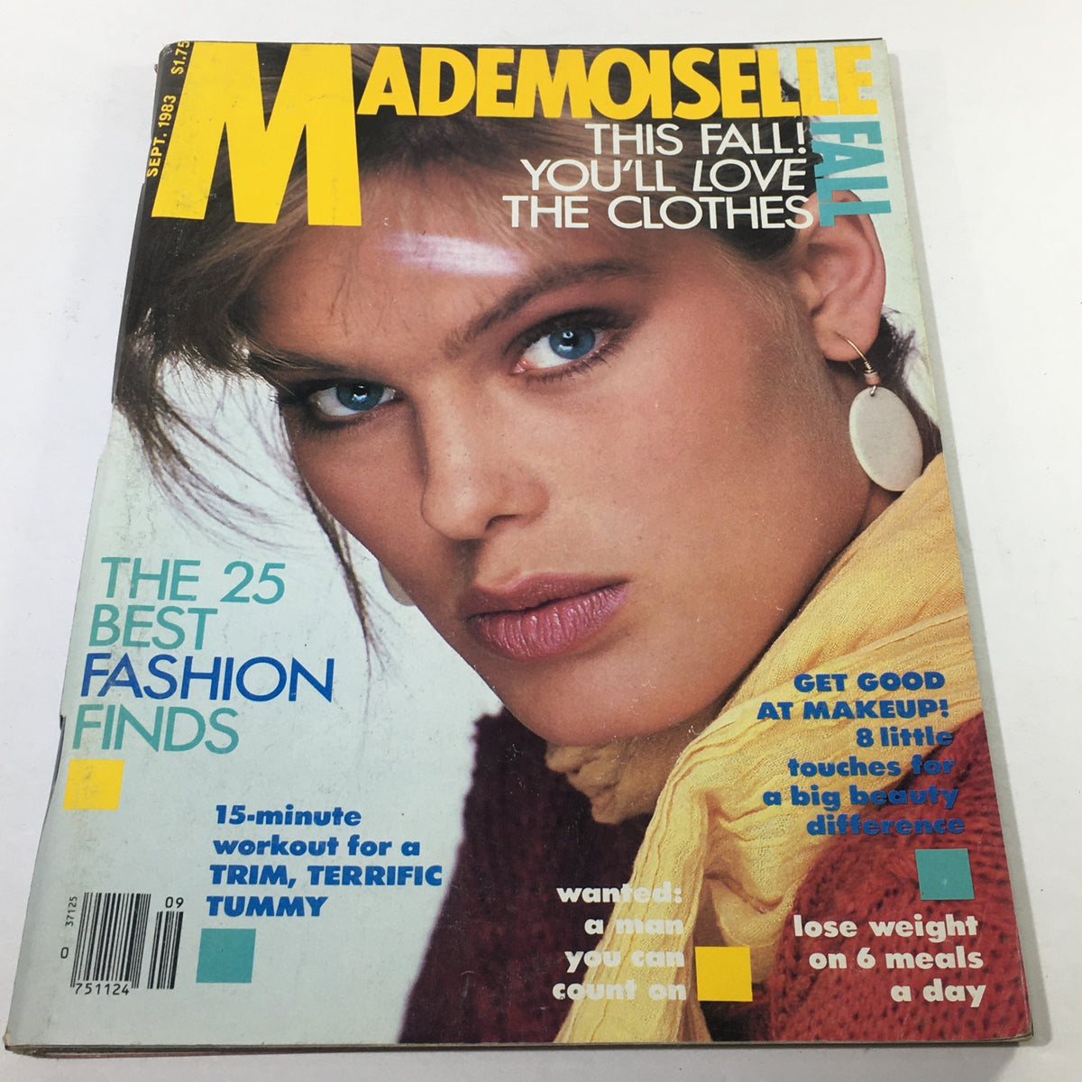 Vintage Mademoiselle Magazine cover from September 1983 featuring a model with striking blue eyes and bold makeup. The cover highlights fashion finds and beauty tips, encapsulating the style of the early 1980s.