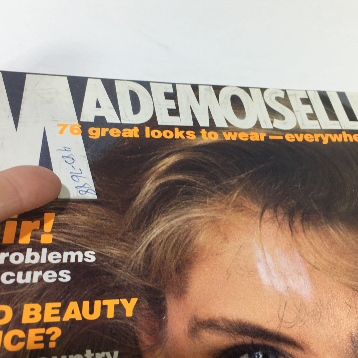 Close-up of VTG Mademoiselle Magazine April 1982 cover, emphasizing text about hair problems and beauty advice, with an image of a model.