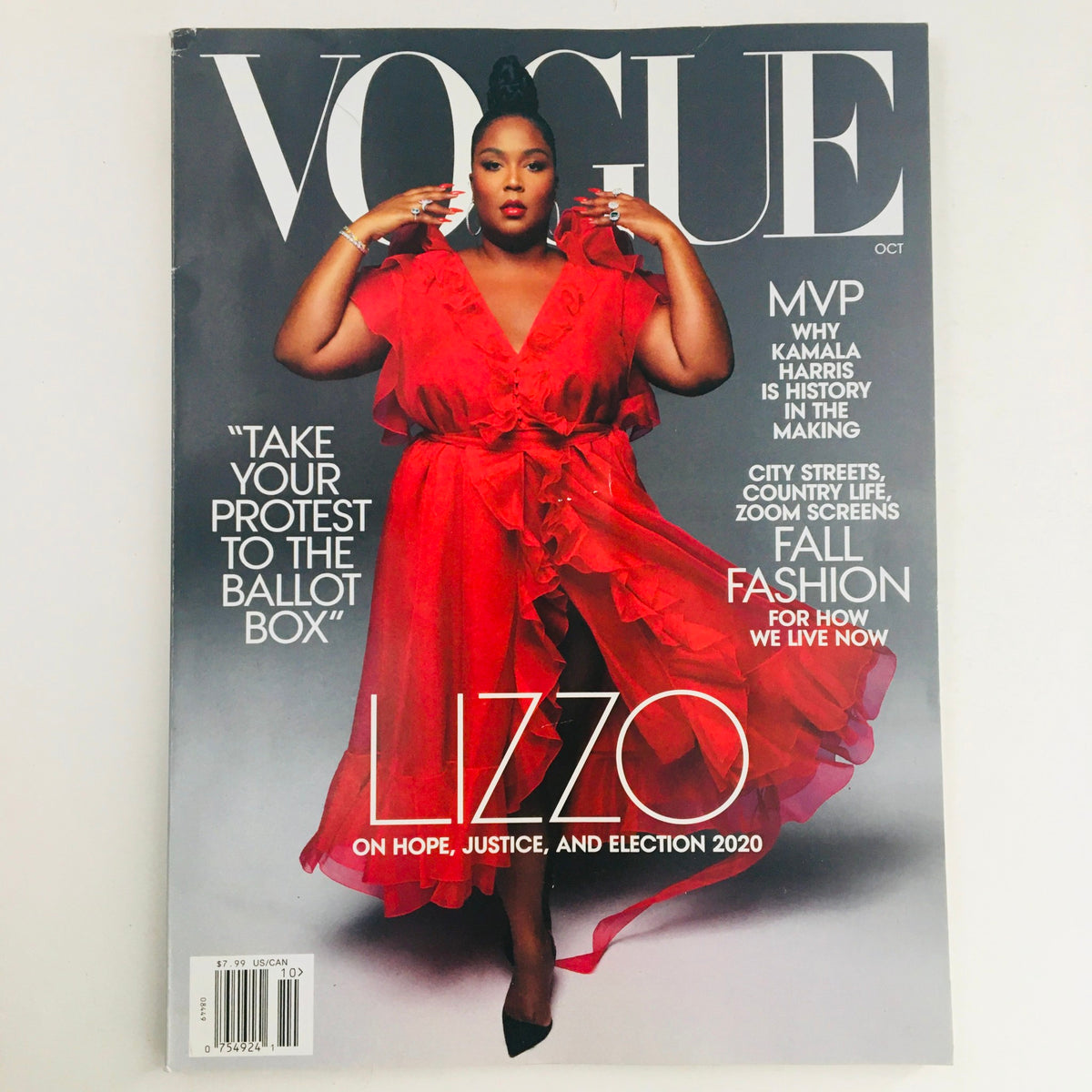 Vogue Magazine October 2020 cover featuring American singer Lizzo in a stunning red dress, highlighting themes of hope, justice, and election 2020.