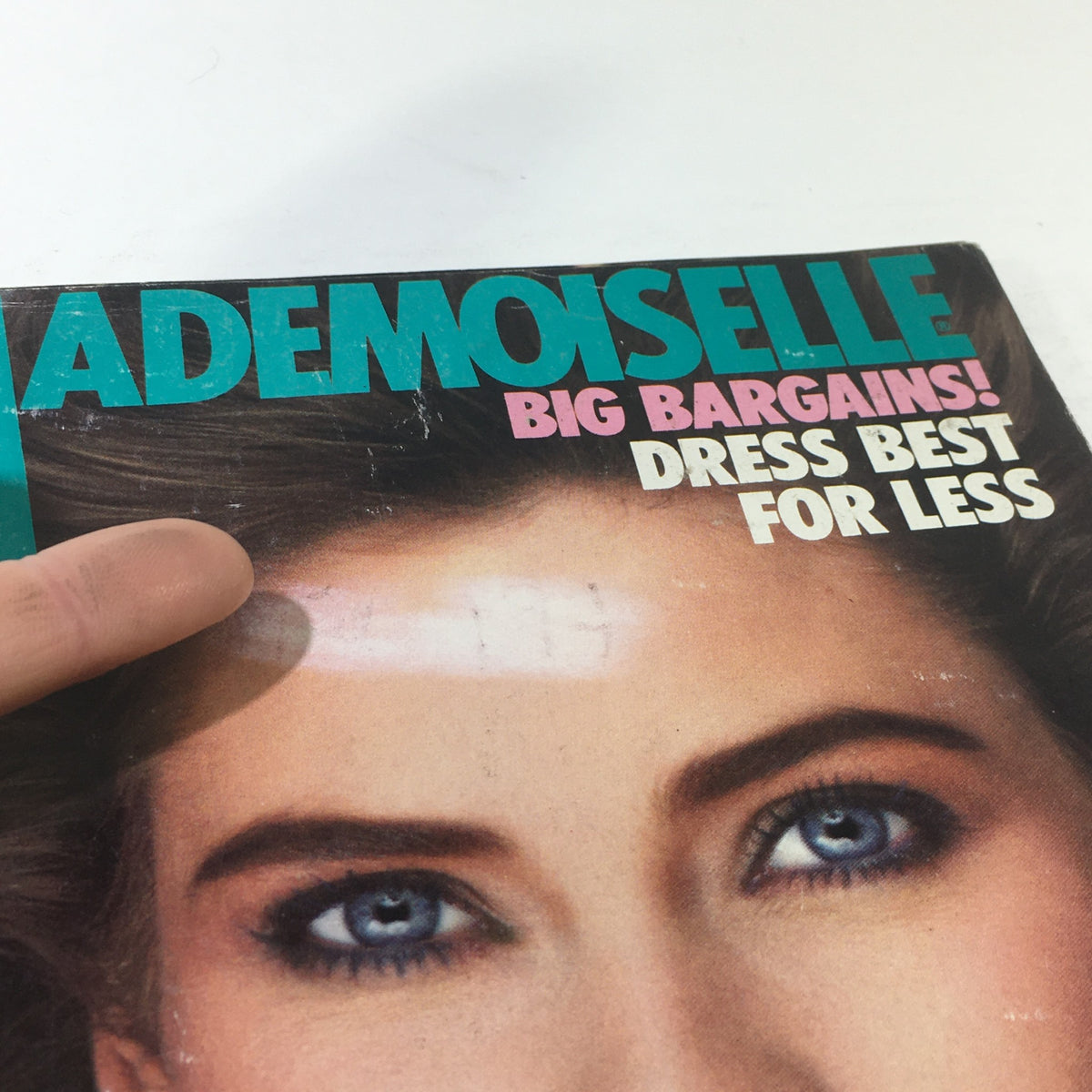 Close-up view of the cover of VTG Mademoiselle Magazine from June 1982, featuring the title prominently displayed. Highlights the magazine's vintage appeal with some surface wear, typical of collectible publications.