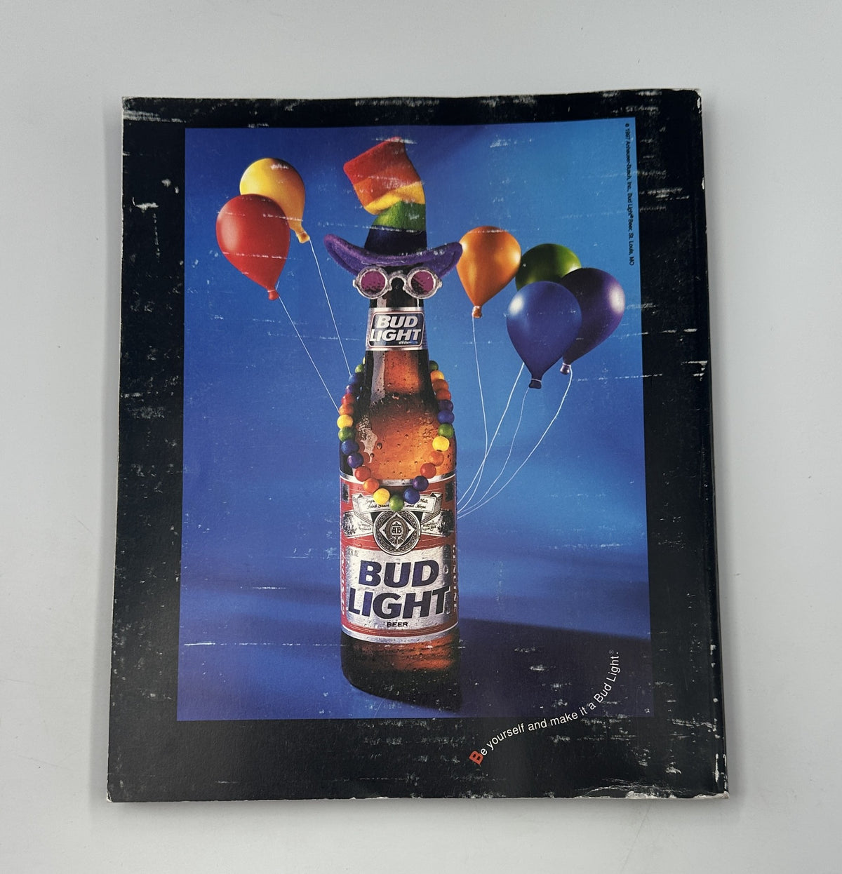 Advertisement in Pride Magazine 1998 featuring Bud Light with colorful balloons and pride-themed decorations, promoting inclusivity and celebration of LGBTQ culture.