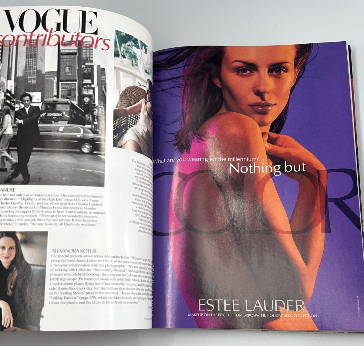 Inside advertisement from Vogue Magazine November 1999 for Estée Lauder featuring a stunning model with vibrant colors, emphasizing the theme 'Nothing but Color' for the holiday collection.