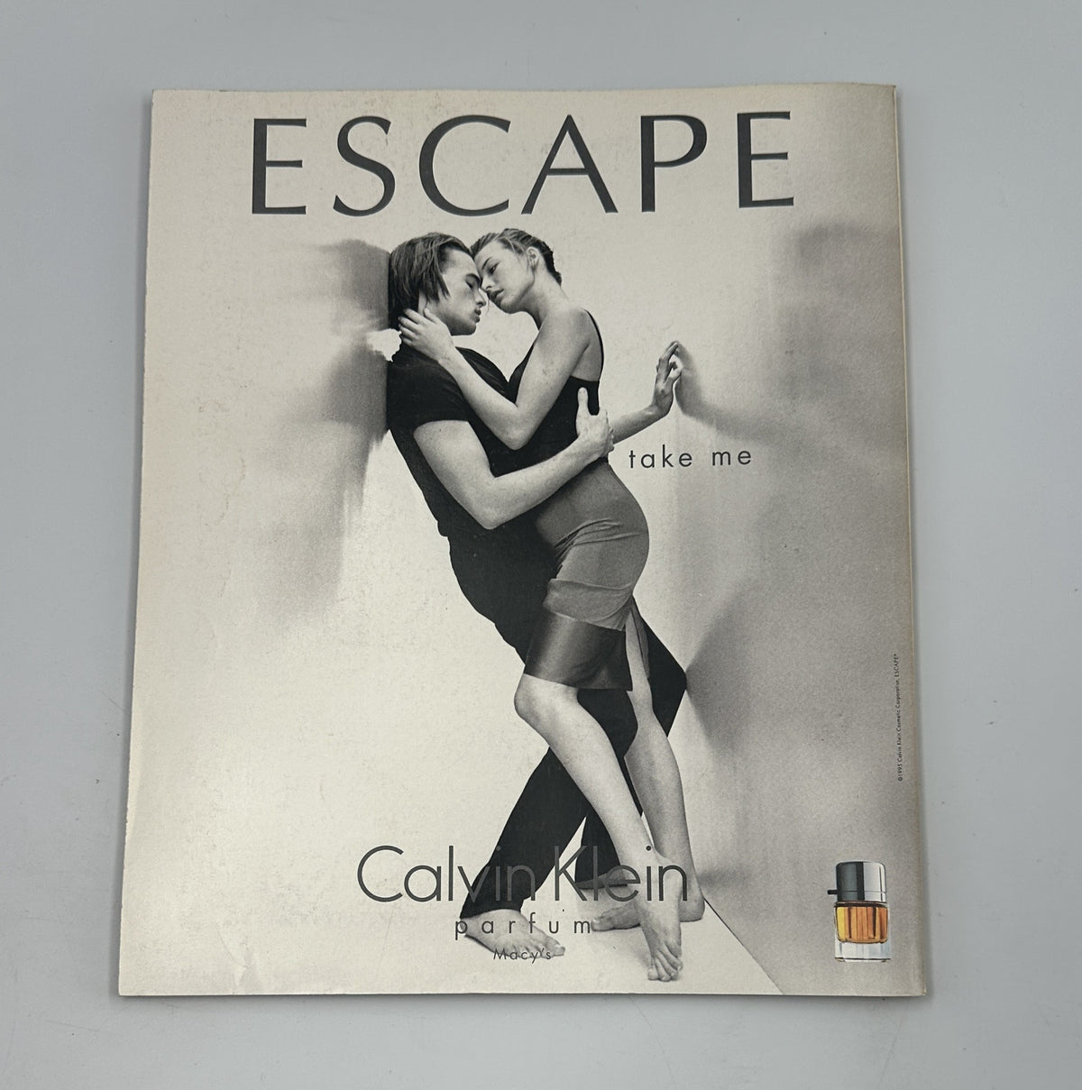 Cover page of an advertisement for Escape by Calvin Klein, featuring a striking image of a couple, included in the context of Martha Stewart Living Magazine December 1995.