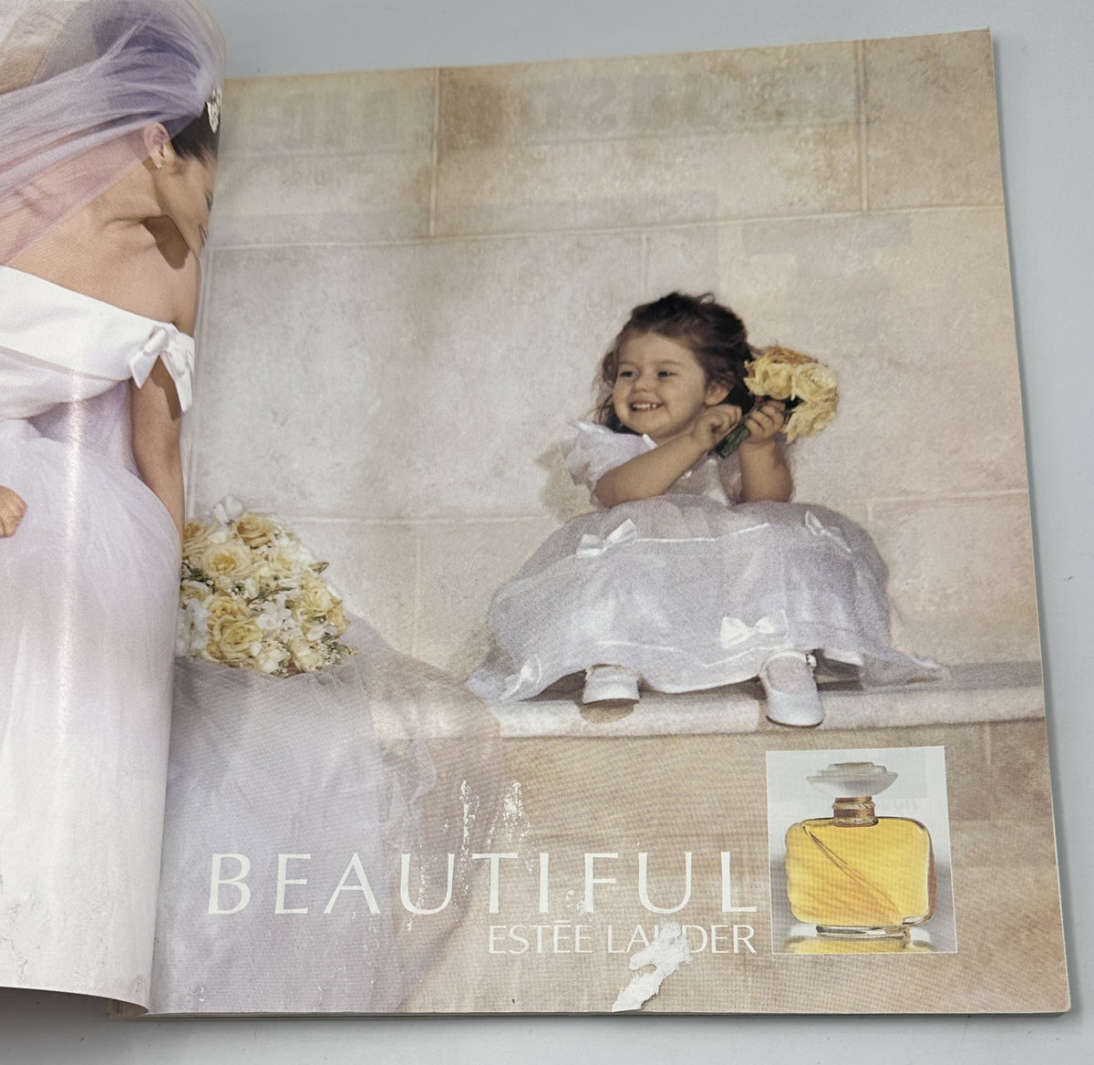 Advertisement page from Martha Stewart Living Magazine February 1996 featuring a child in a wedding dress and a beautiful Estee Lauder perfume bottle.