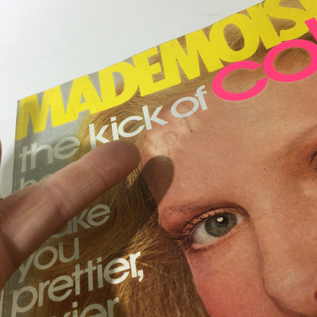 Close-up view of the Mademoiselle Magazine March 1976 cover, highlighting the tagline 'the kick of Color!' alongside the model's striking features and fashion elements.