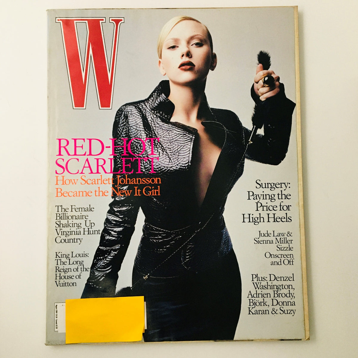 W Magazine August 2004 cover featuring Scarlett Johansson in a stylish black outfit, highlighting the theme 'Red-Hot Scarlett' and the article on her rise as the new It girl.