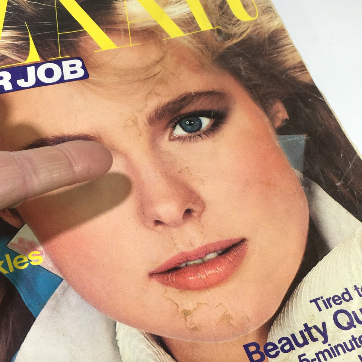 VTG Bazaar Magazine: March 1984 - Nancy DeWeir Cover showing close-up detail of the model's face, with visible wear on the magazine cover, revealing its vintage character.