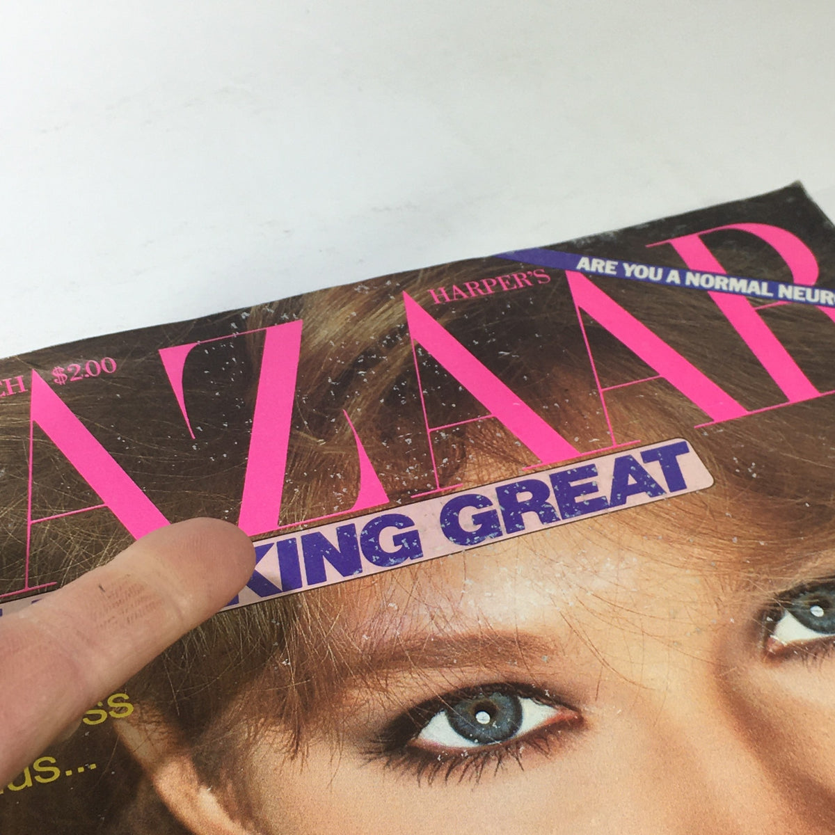 Close-up of the cover of VTG Bazaar Magazine: March 1982 highlighting the text 'YOU! LOOKING GREAT' with a finger pointing at the title, showcasing its vintage appeal.