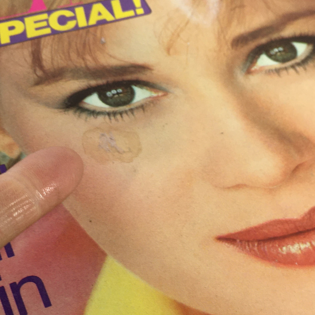 Close-up of the May 1982 Vintage Bazaar Magazine cover featuring Kim Alexis, highlighting a minor imperfection near her eye.
