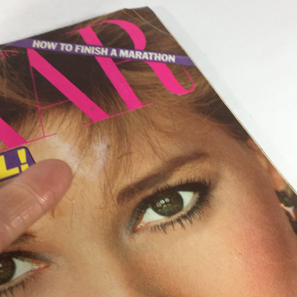 Detail view of the May 1982 Vintage Bazaar Magazine cover, focusing on Kim Alexis and a smudge above her eye.