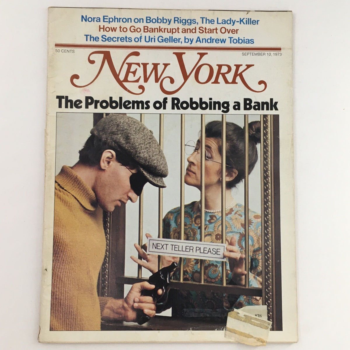 Cover of New York Magazine from September 10, 1973, featuring an article by Nora Ephron on Bobby Riggs, The Lady-Killer. The image depicts a scene with a robber in disguise and a bank teller behind bars, highlighting the magazine's intriguing storytelling from the 1970s.