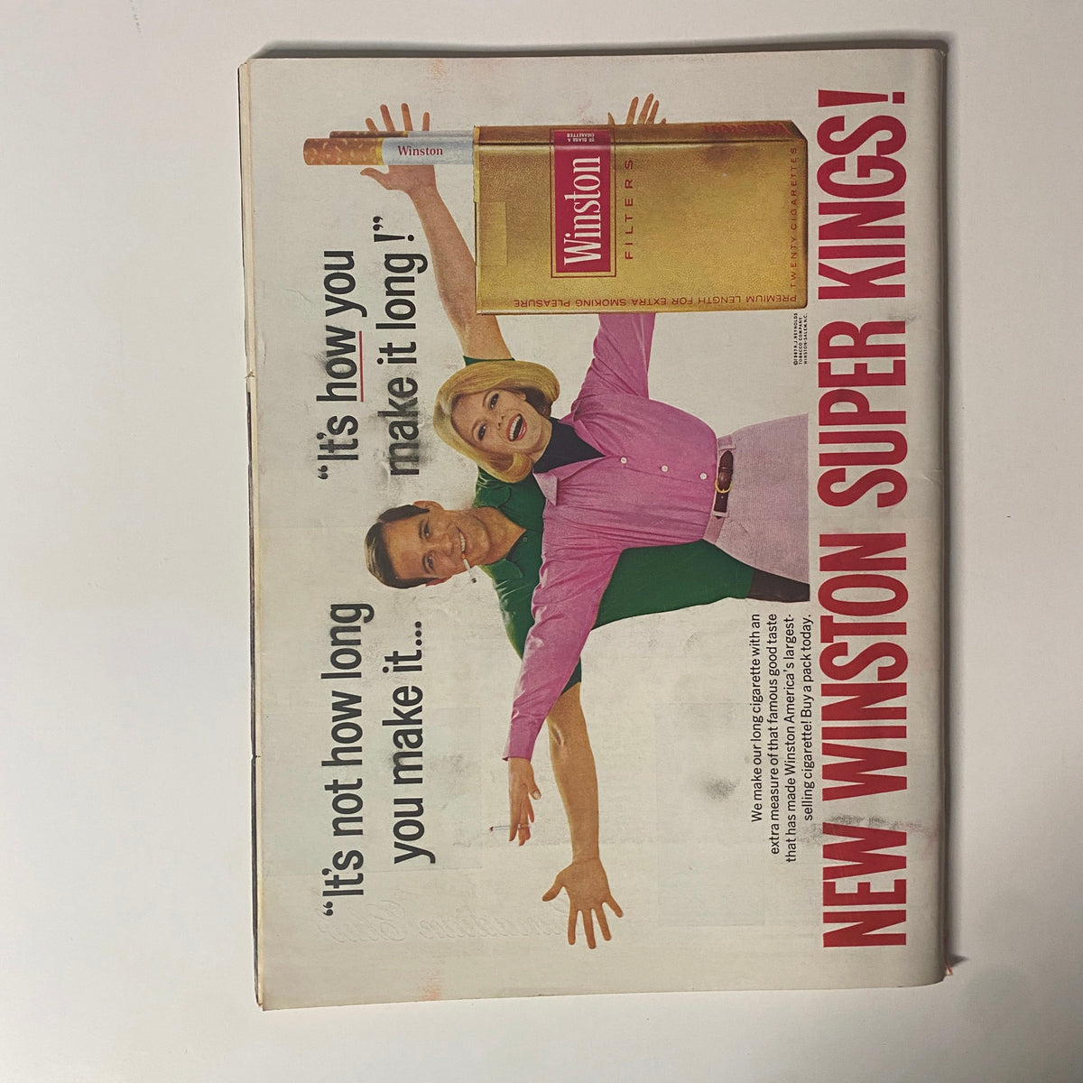 Advertisment page from Time Magazine, featuring Winston Super Kings cigarettes with a slogan and imagery of a man and woman.