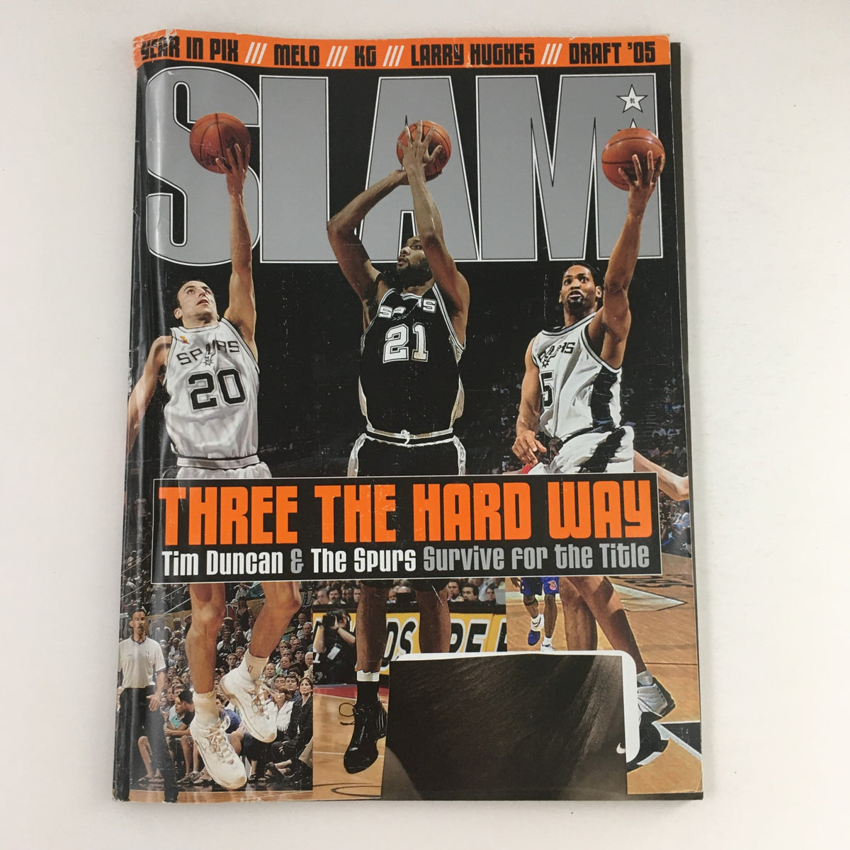 Slam Magazine cover from September 2005 featuring Manu Ginóbili, Tim Duncan, and Robert Horry, titled 'Three the Hard Way: Tim Duncan & The Spurs Survive for the Title'.