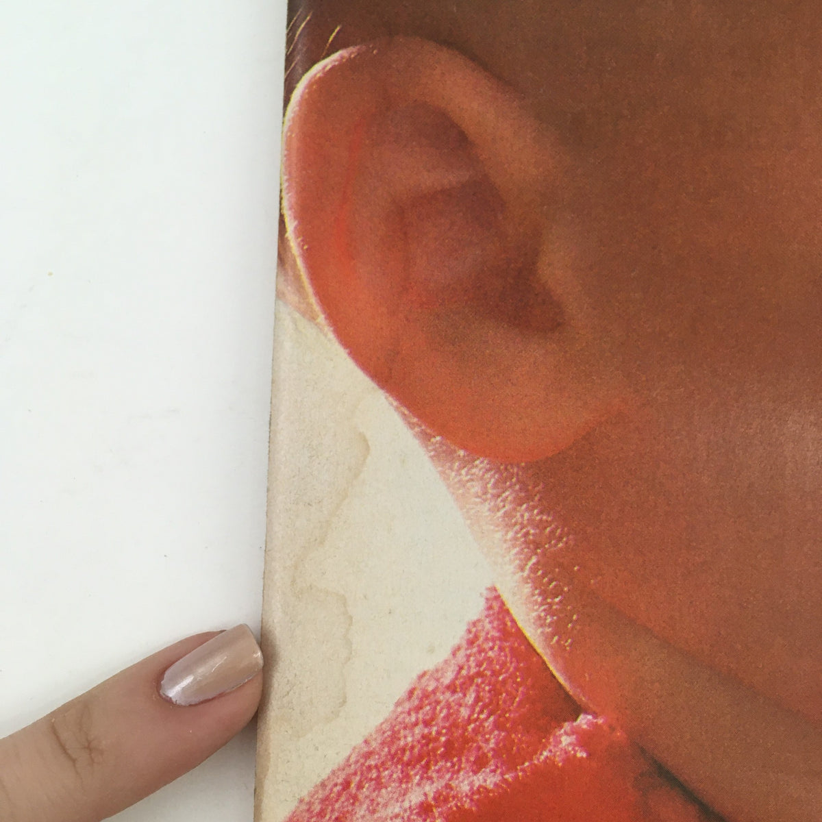 Close-up of the ear and head of a baby featured on the cover of American Baby Magazine February 1981 - A Special Nutrition Issue.