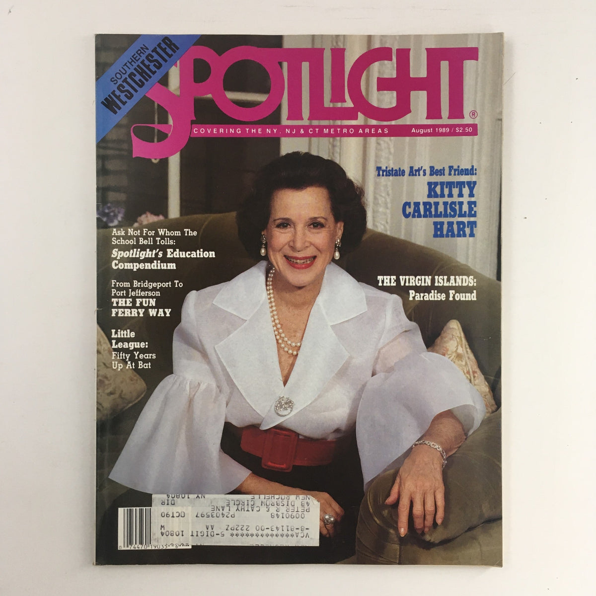 Cover of Spotlight Southern Westchester magazine, August 1989 edition featuring Kitty Carlisle Hart. The cover showcases the title in bold pink letters with a blue banner and includes a portrait of Kitty Carlisle Hart in a stylish outfit, accentuated by pearls. Ideal for collectors of vintage magazines and fans of the arts.