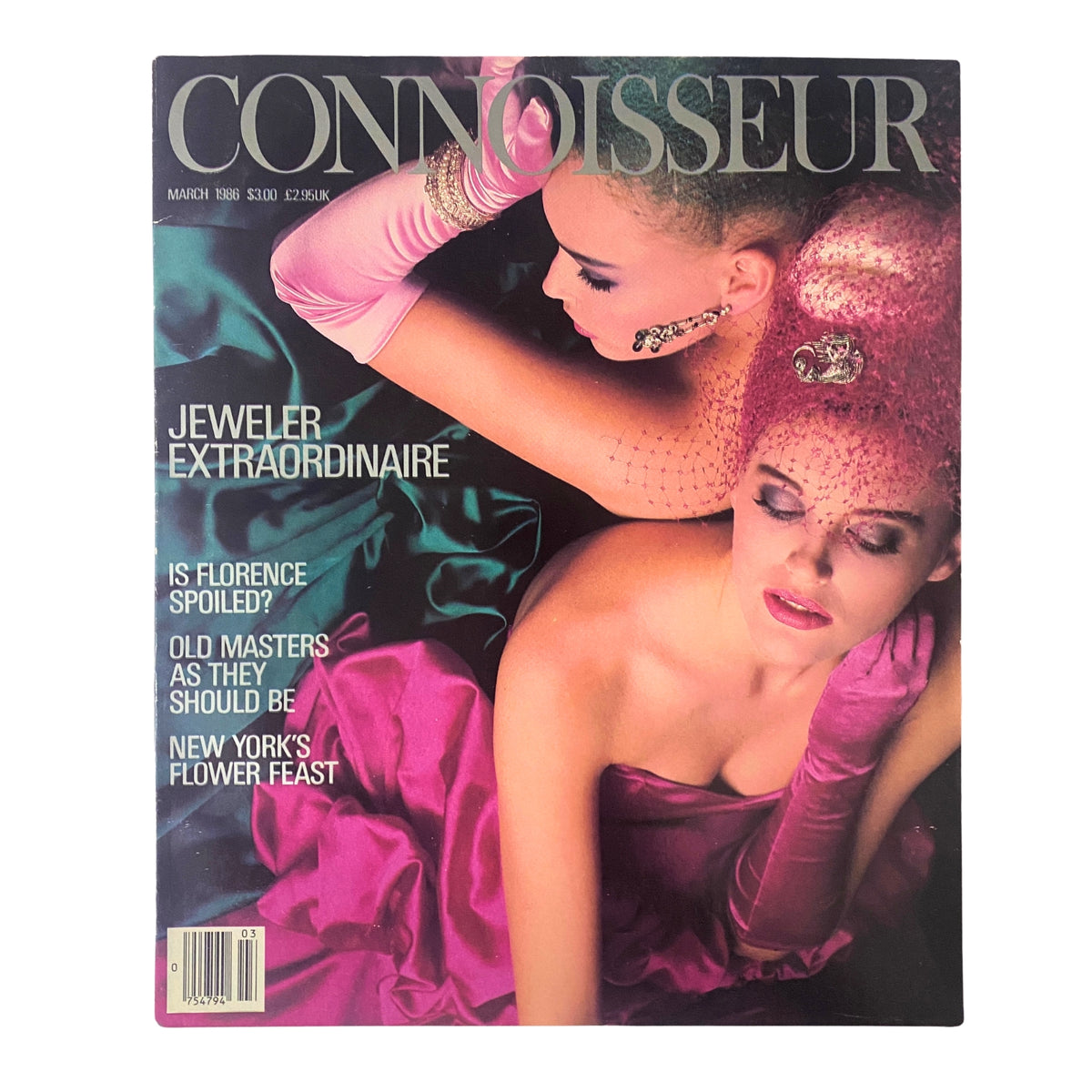 Cover of Connoisseur Magazine March 1986 featuring the title 'Jeweler Extraordinaire' with a vibrant fashion photograph showing two models in elegant attire, showcasing luxury and high culture.