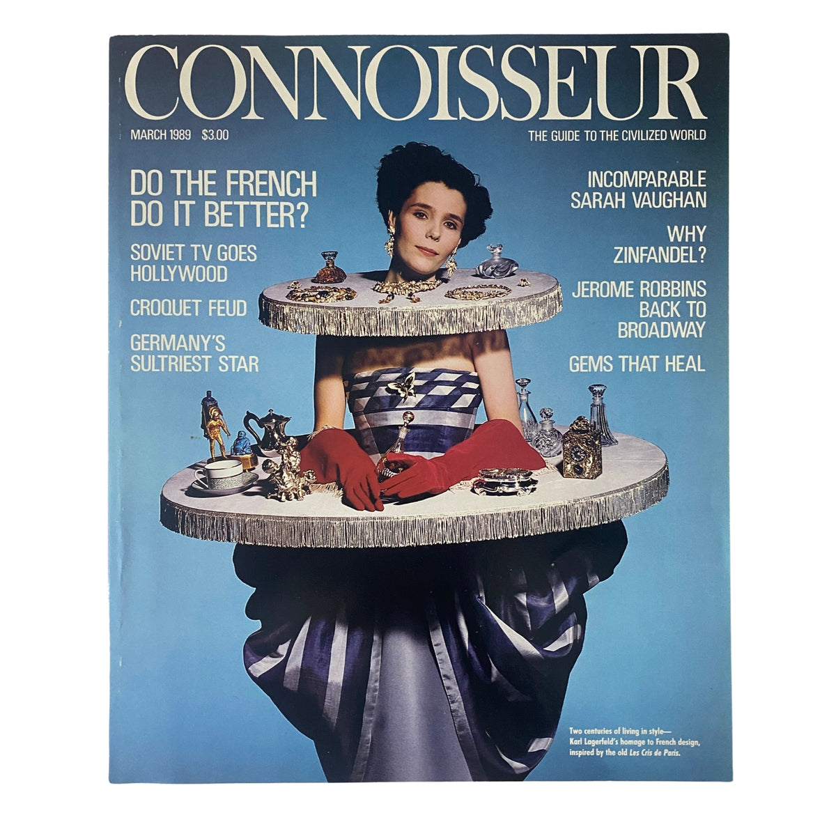 Cover of Connoisseur Magazine March 1989 featuring an homage to Karl Lagerfeld, showcasing a model in a stylish dress with red gloves and displaying elegant collectibles.