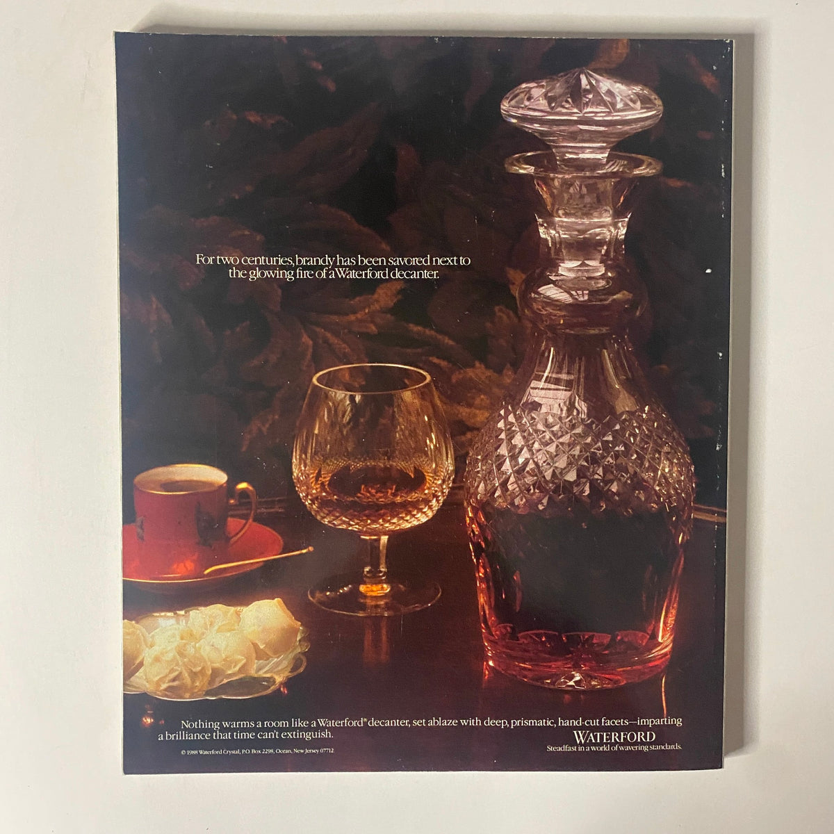 Connoisseur Magazine March 1989, displaying an advertisement for Waterford crystal, highlighting the beauty of a decanter and glassware.