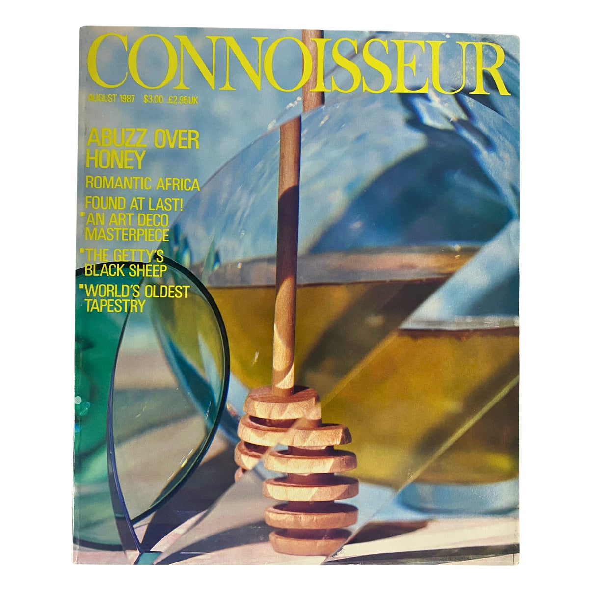 Connoisseur Magazine August 1987 cover featuring the theme 'Abuzz Over Honey' with elements of honey and vibrant colors. This vintage magazine showcases culture, art, and fine living.