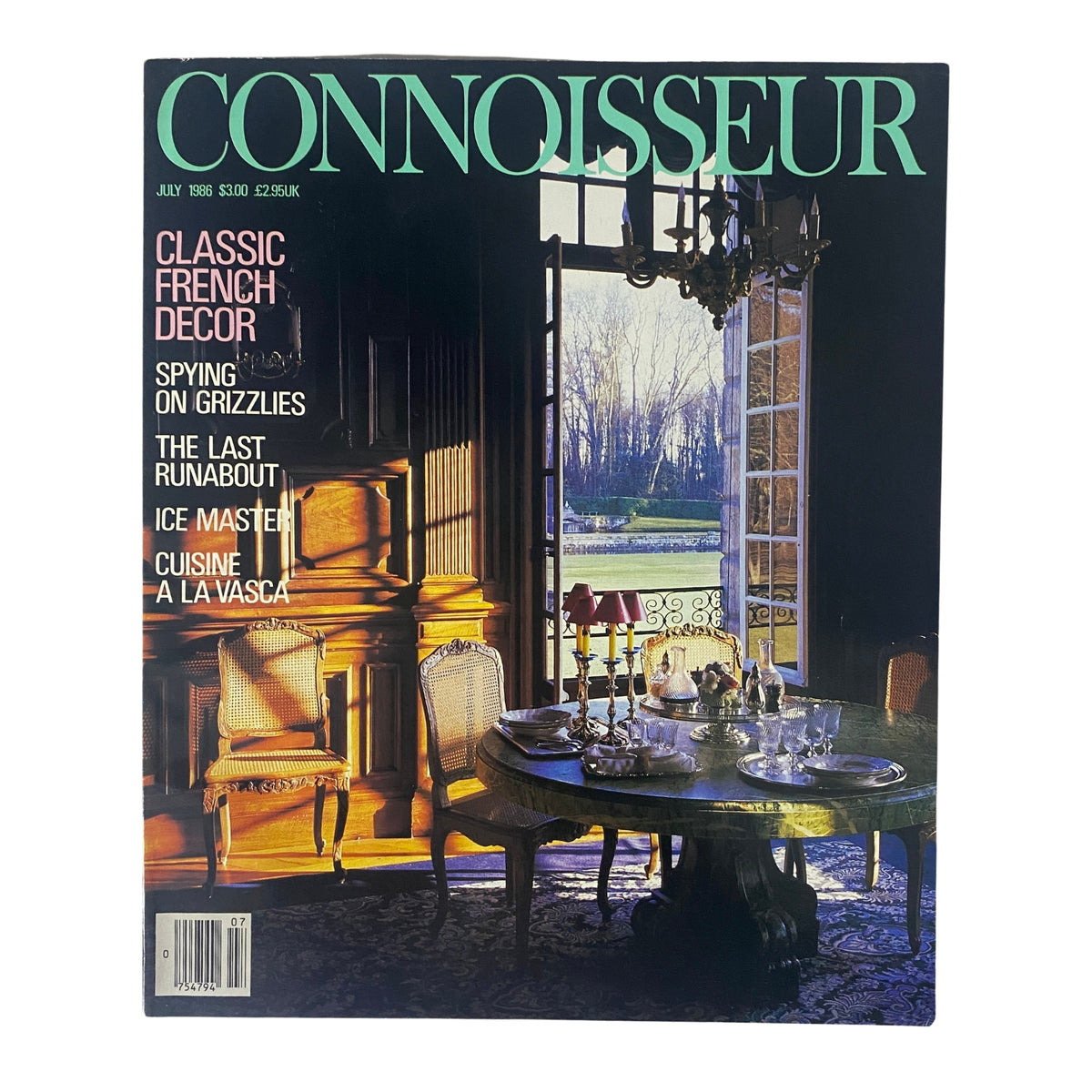 Cover of Connoisseur Magazine July 1986 featuring a Classic French Door theme, showcasing a beautifully set dining table with elegant decor and large windows allowing natural light to illuminate the room.