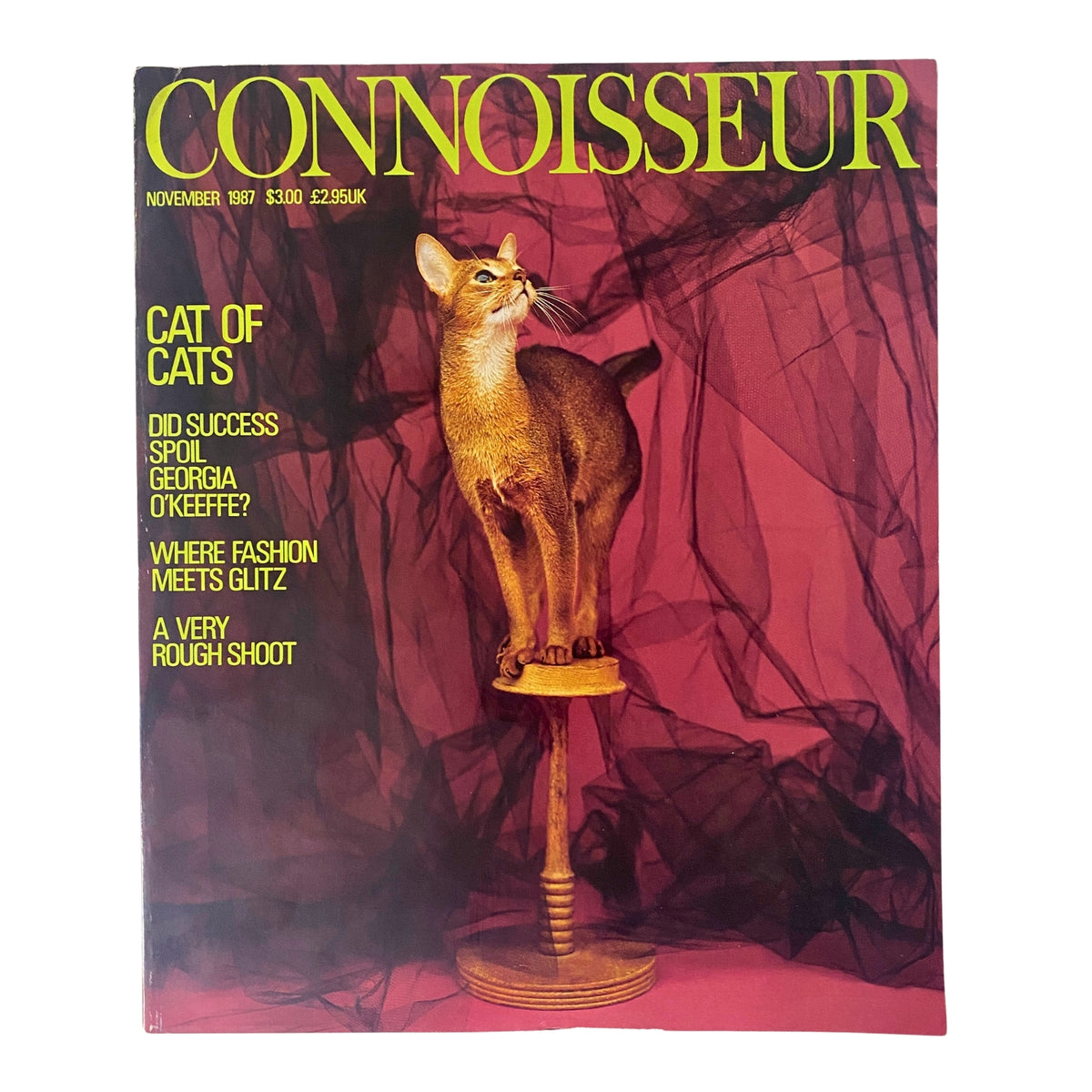 Cover of Connoisseur Magazine November 1987 titled 'Cat of Cats', featuring a sleek Abyssinian cat displayed on a pedestal against a vibrant red background with elegant text presenting various articles.