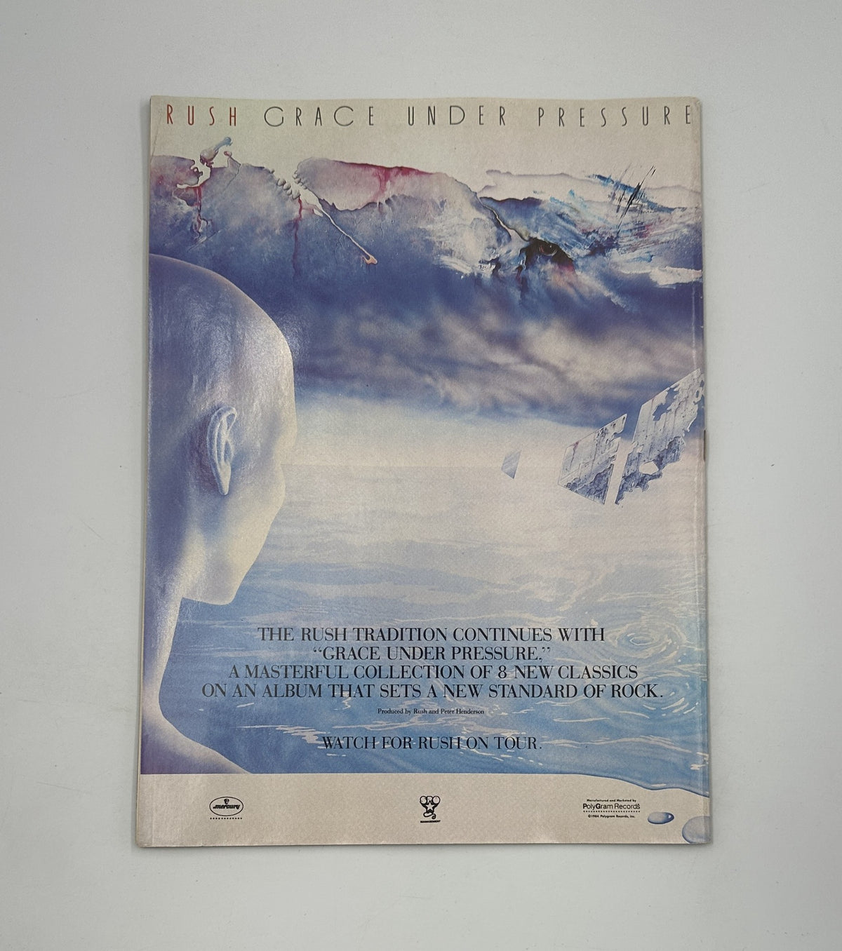 Rush Grace Under Pressure album cover featuring a surreal image of a human silhouette against an abstract background. Accompanied by the text describing the album as a masterful collection of 8 new classics that sets a new standard of rock, and promoting an upcoming Rush tour.